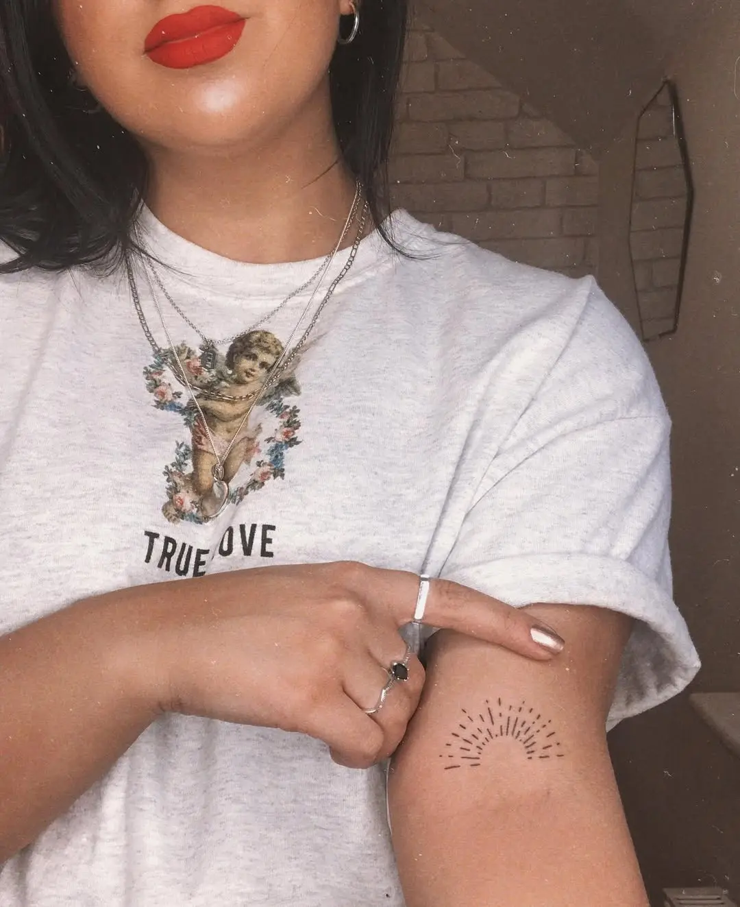 Charming sunrise tattoo on a woman's arm