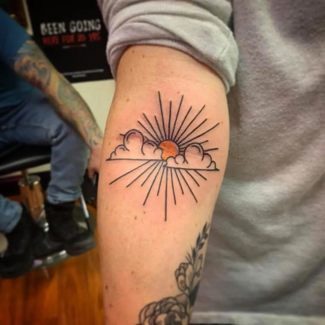 Stunning sunrise tattoo with rays and clouds