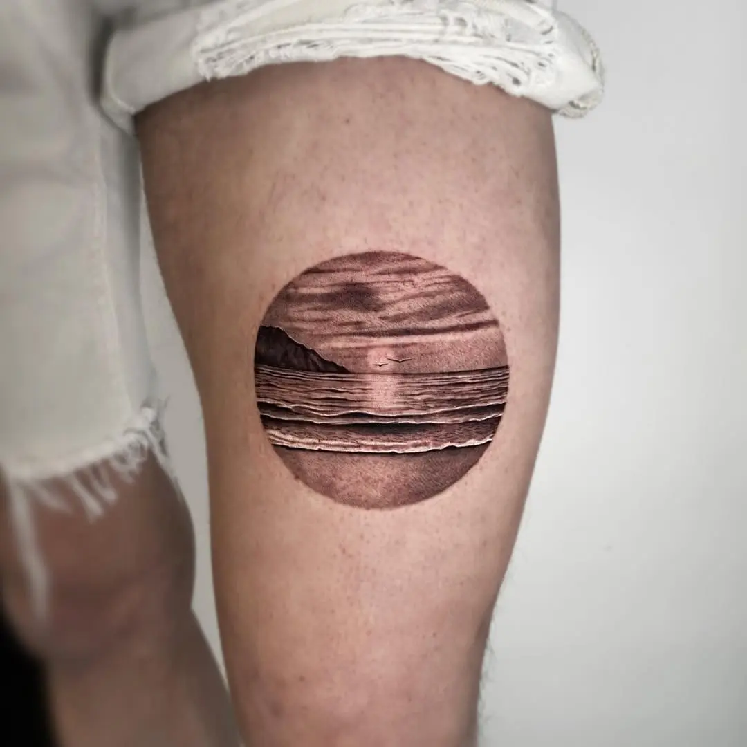 Stunning sunrise tattoo capturing ocean tranquility