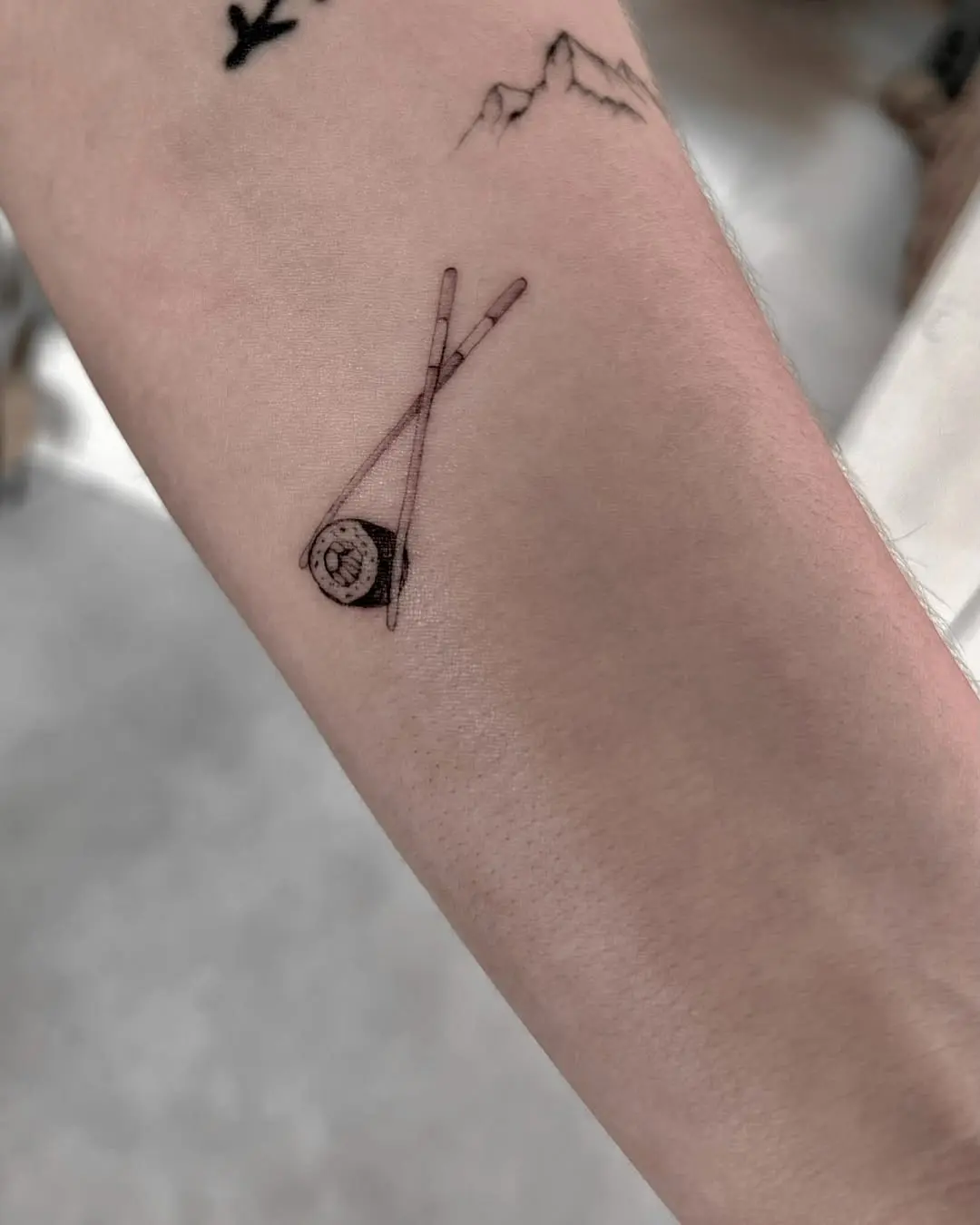 Charming sushi roll with chopsticks tattoo