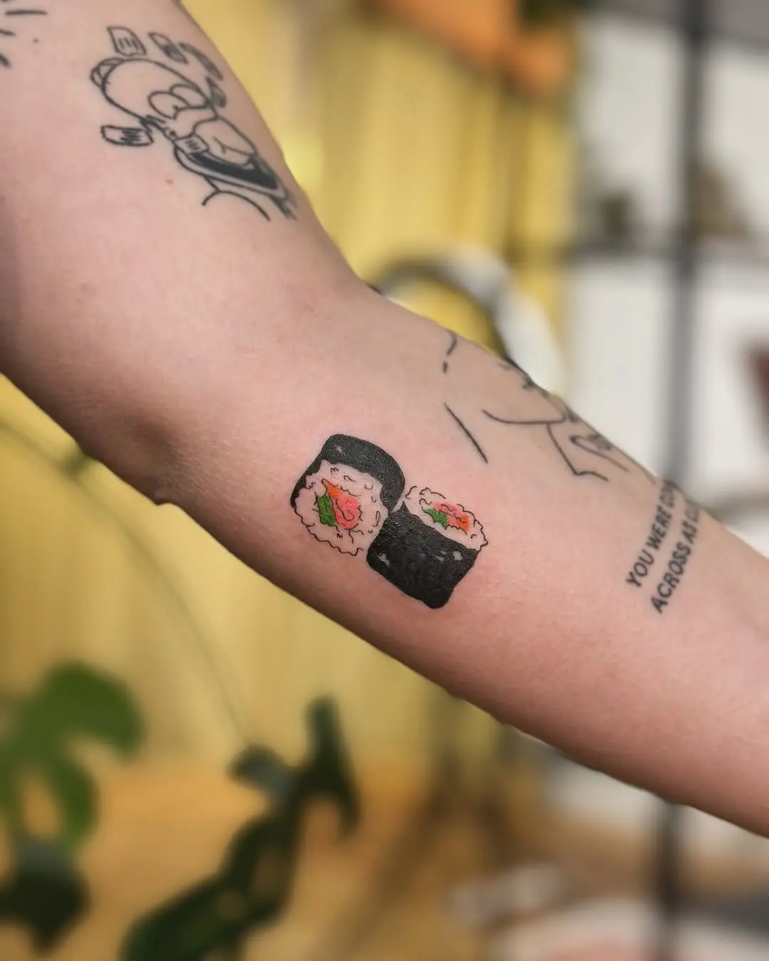 Whimsical sushi tattoo showcasing playful art style