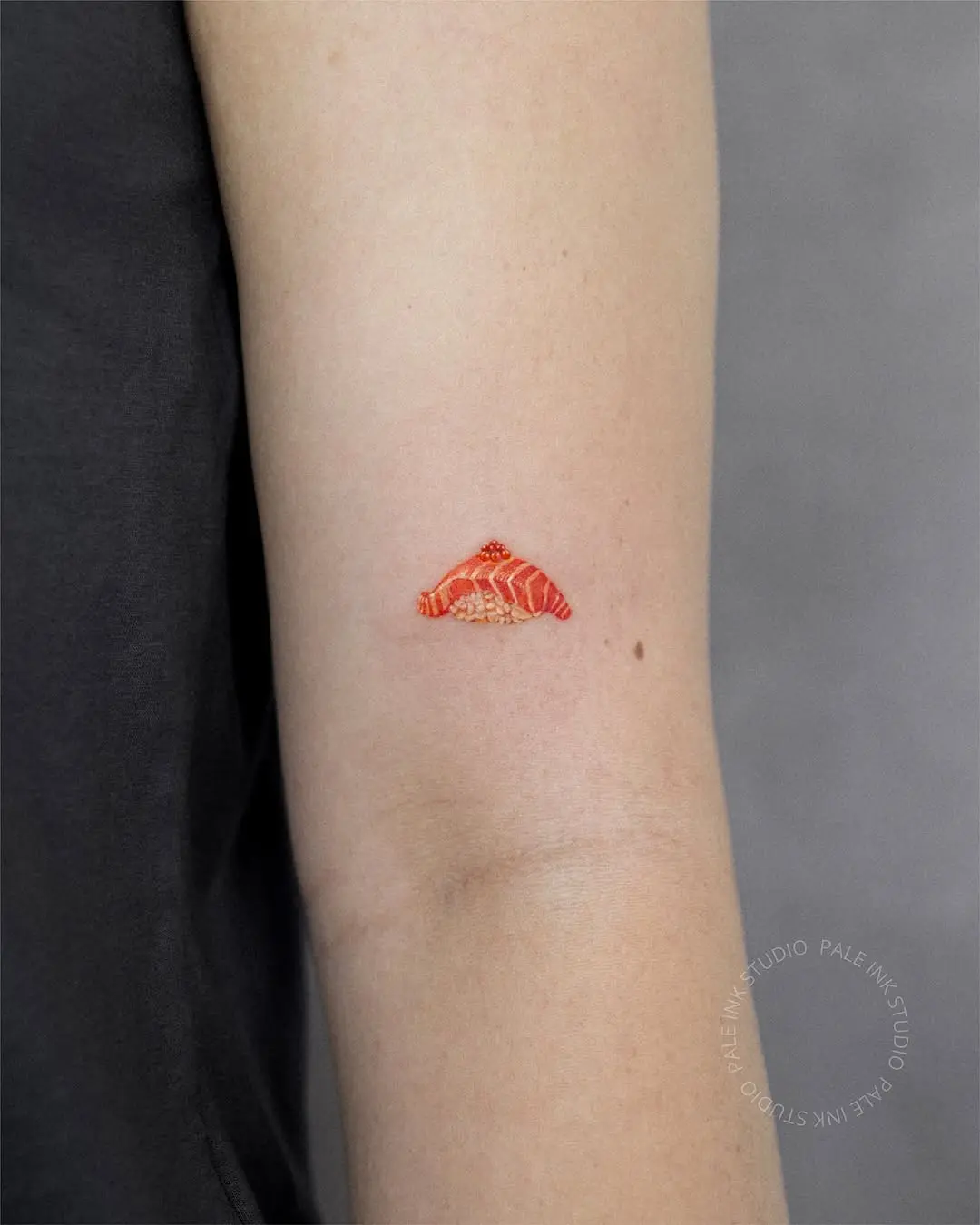 Vibrant sushi tattoo featuring salmonskin artistry