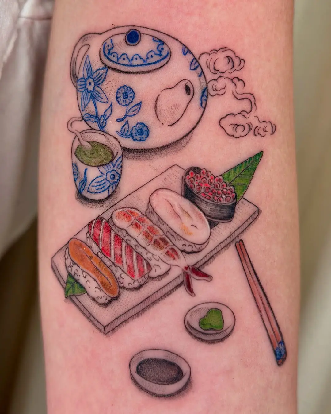 Charming sushi tattoo with tea and utensils