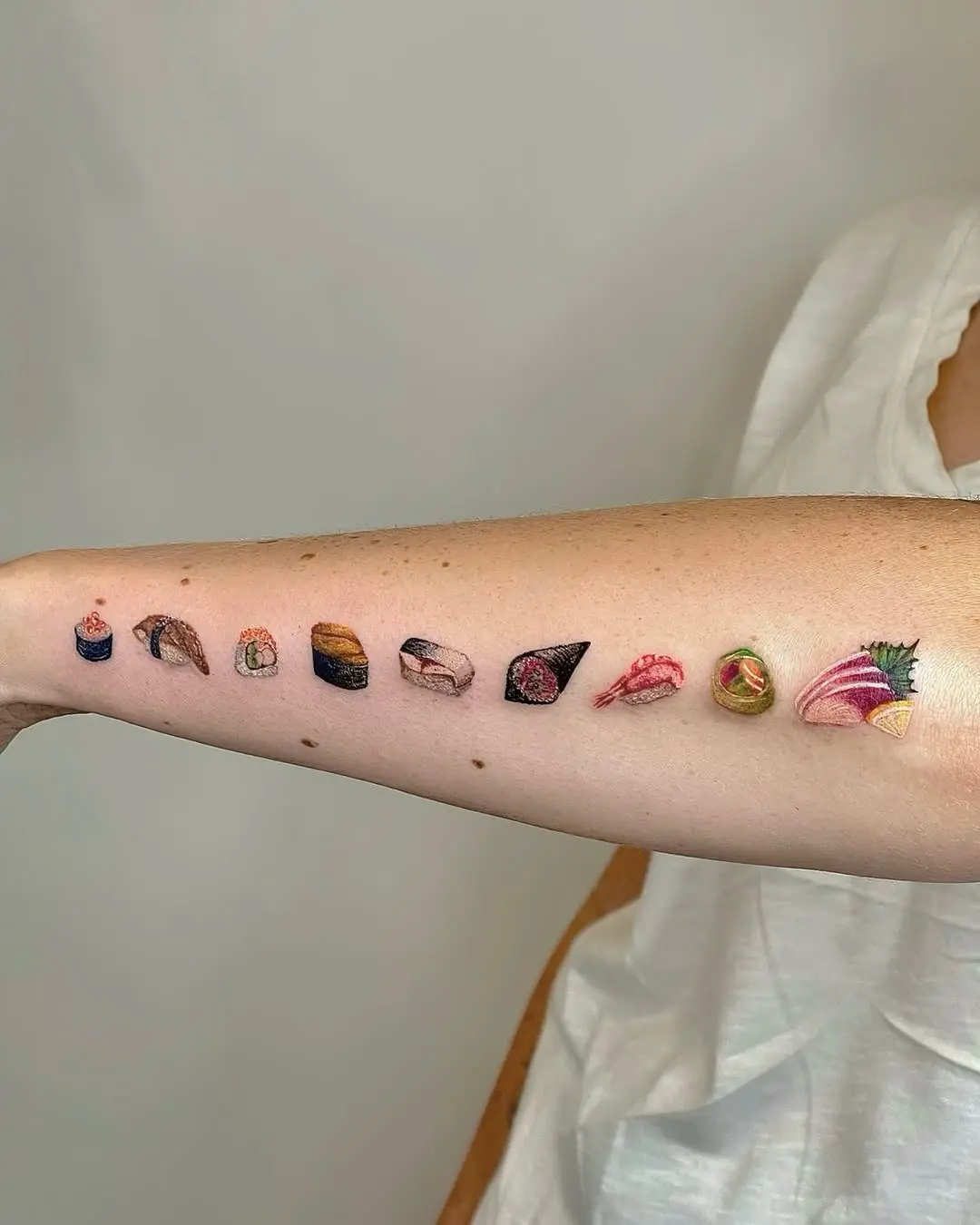 Colorful sushi tattoo collection on arm