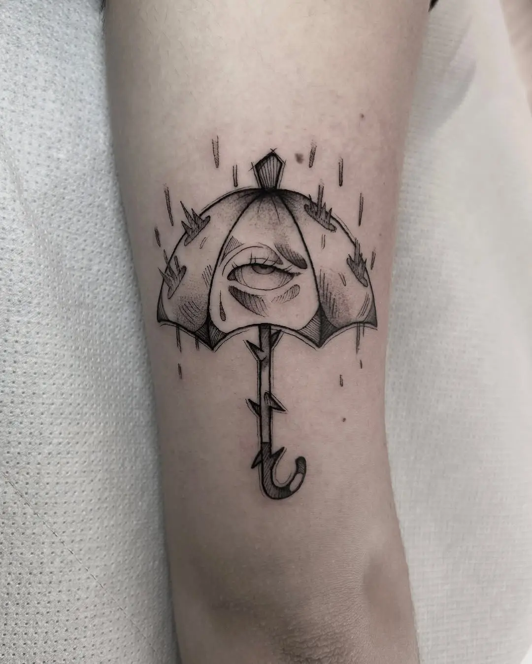 Striking umbrella tattoo with eye and rose