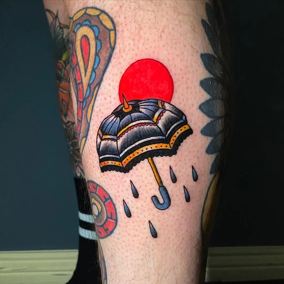 Bold umbrella tattoo with a vibrant sun backdrop
