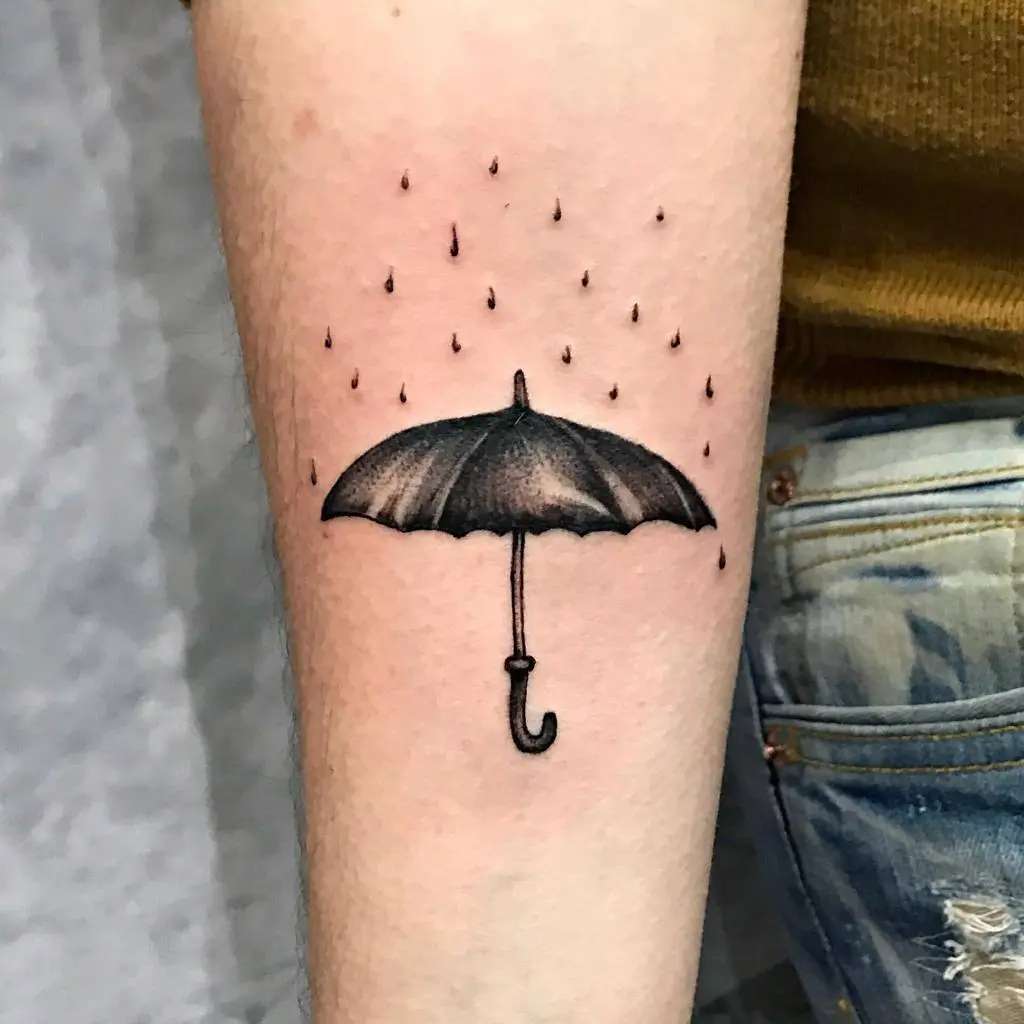Stylish umbrella tattoo with raindrops design