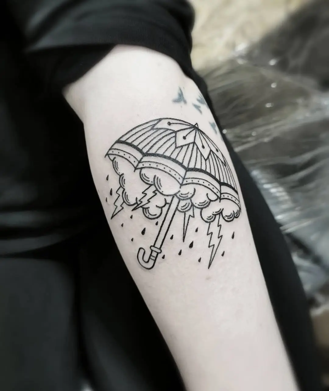 Stylish umbrella tattoo with stormy vibes