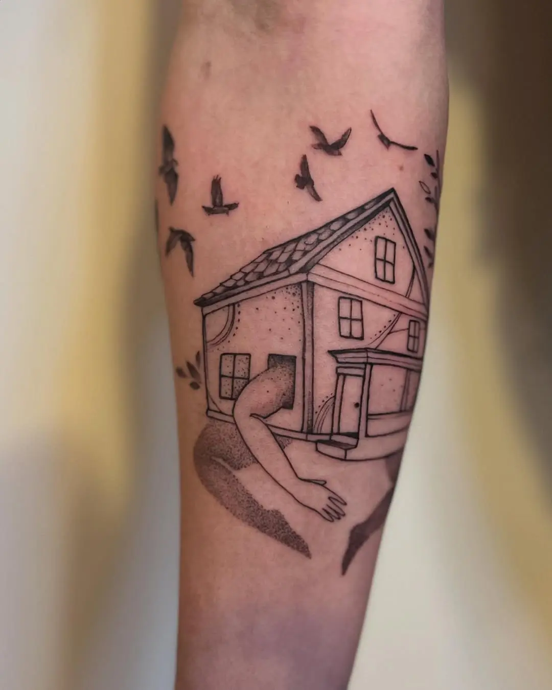 Whimsical house tattoo blending nature and home
