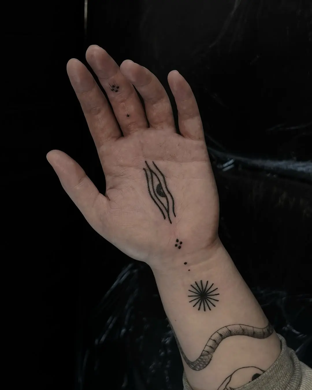 Intricate black ink palm tattoo design