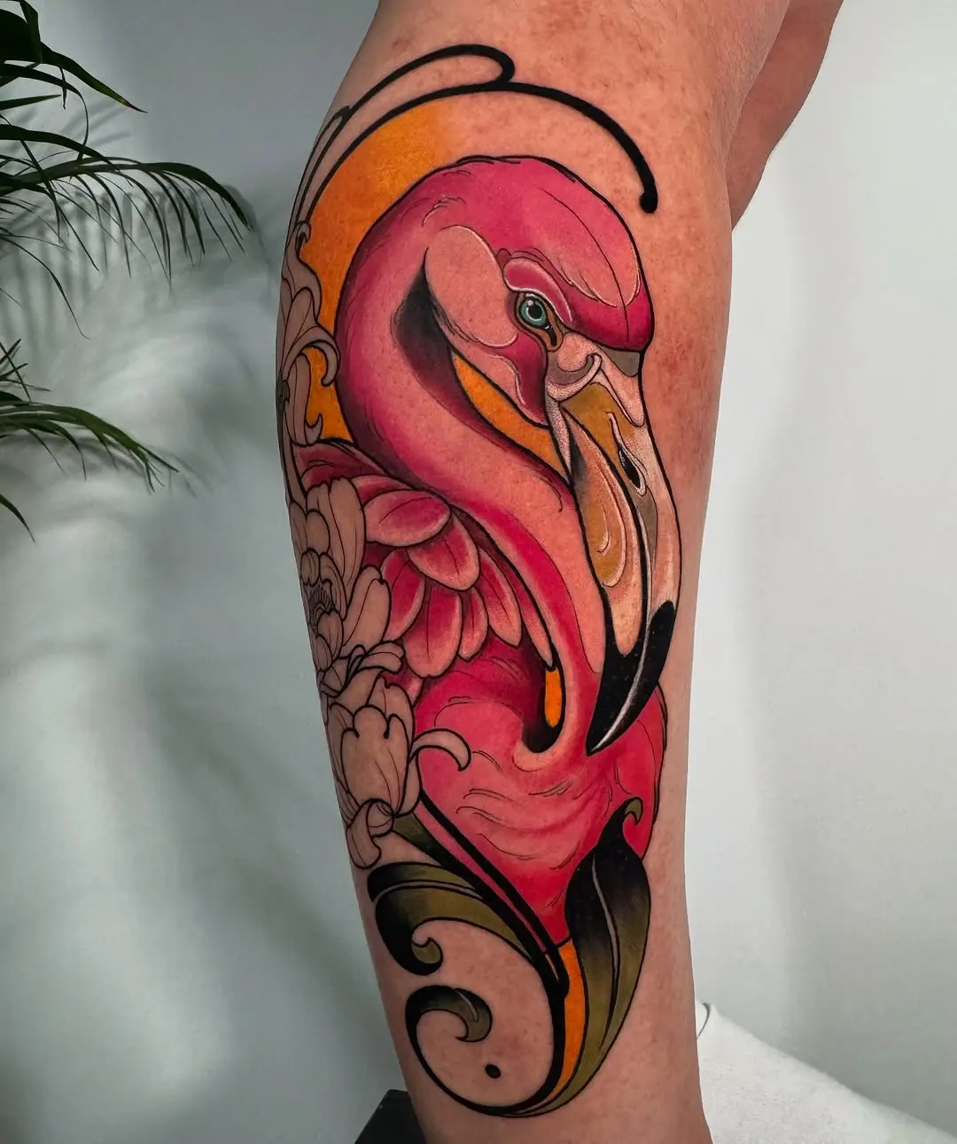 Vibrant flamingo tattoo with floral elements