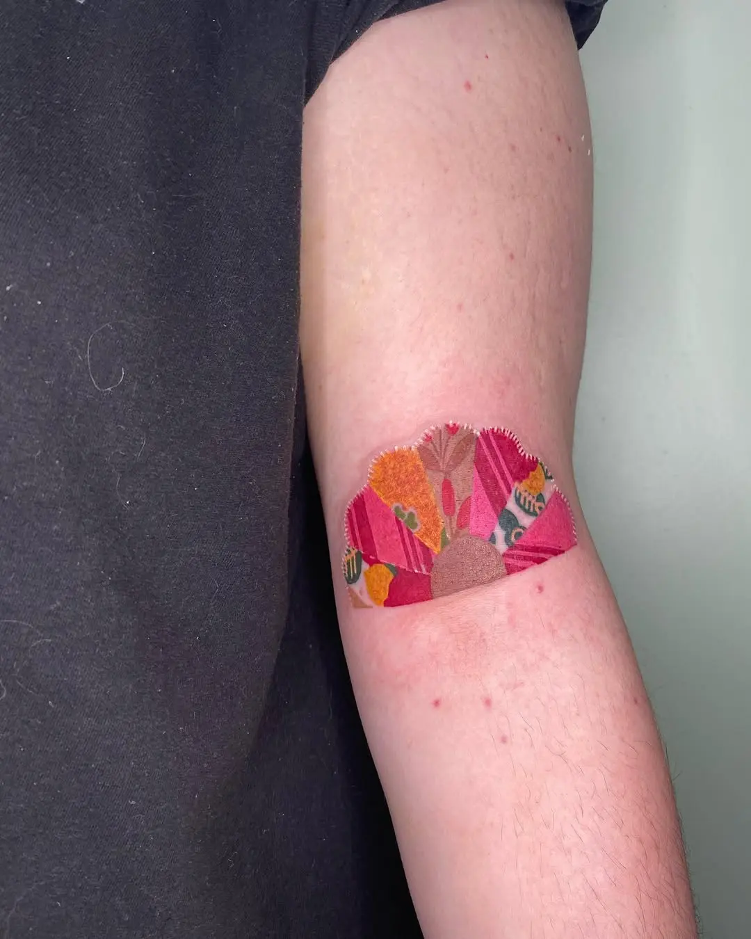 Colorful patchwork quilt tattoo on the arm