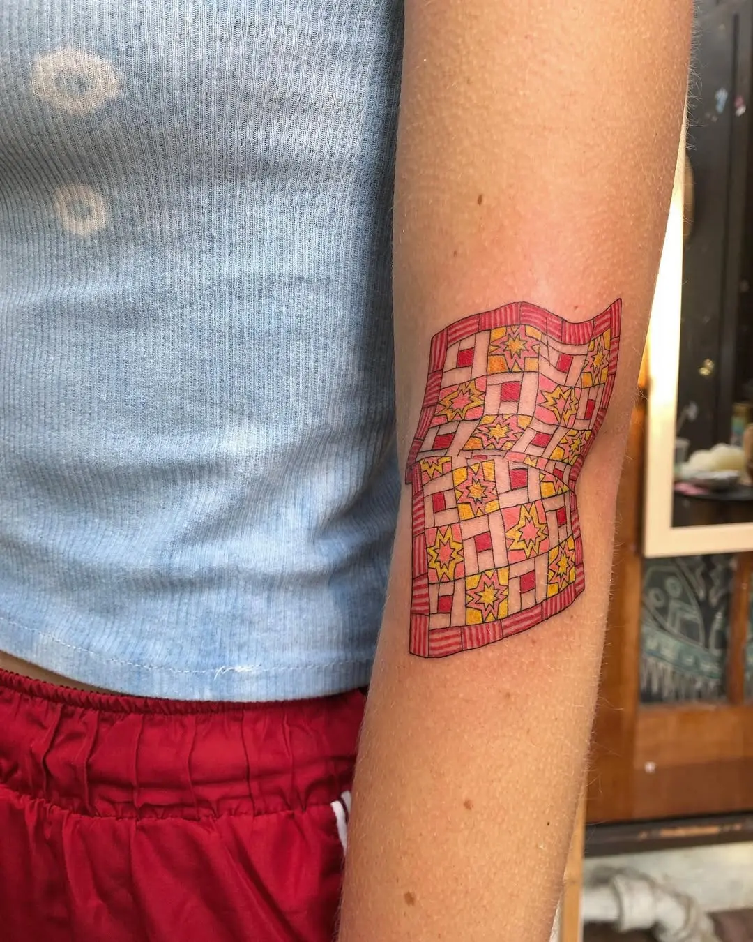 Colorful quilt tattoo on the arm
