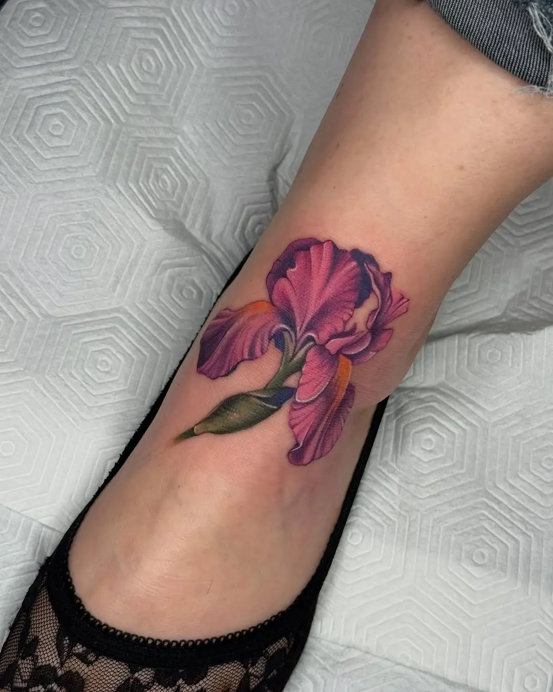 Stunning violet iris tattoo on the ankle