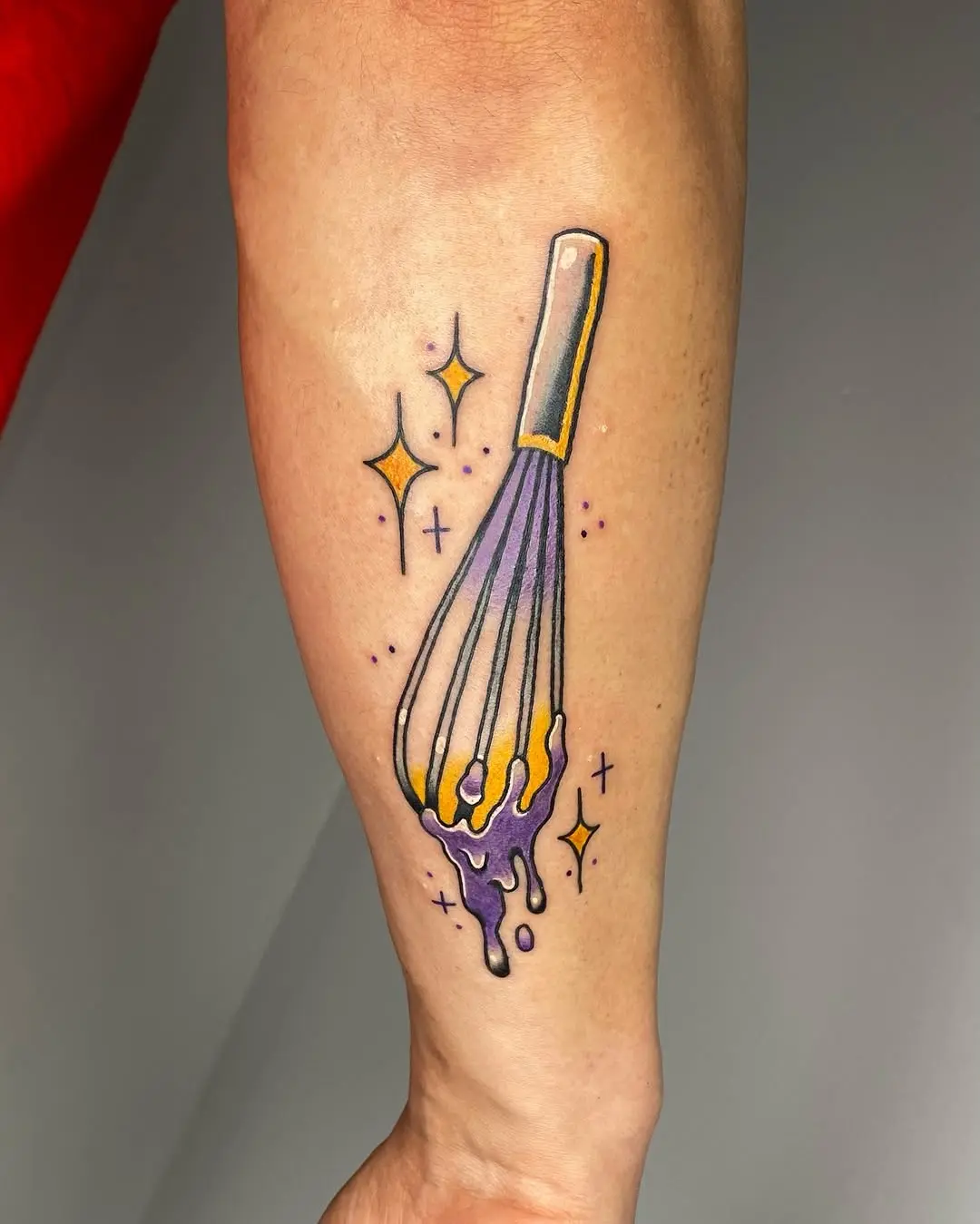 Colorful whisk tattoo with a playful vibe
