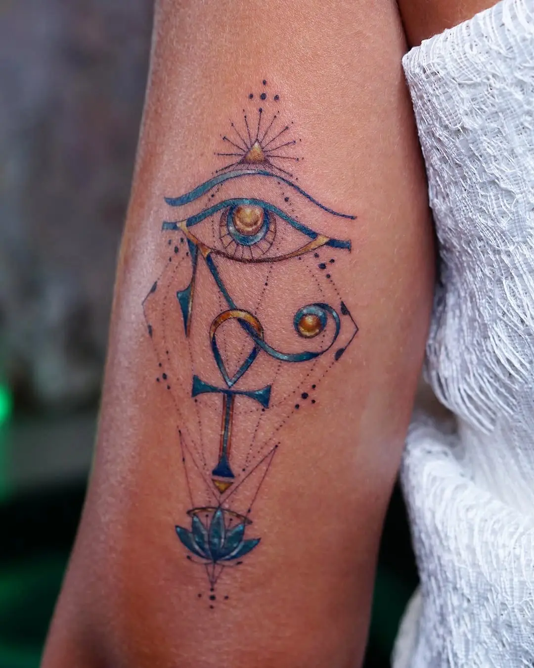 Intricate ankh and eye tattoo design