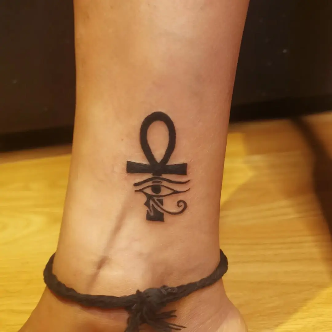 Elegant ankh tattoo with Eye of Horus details