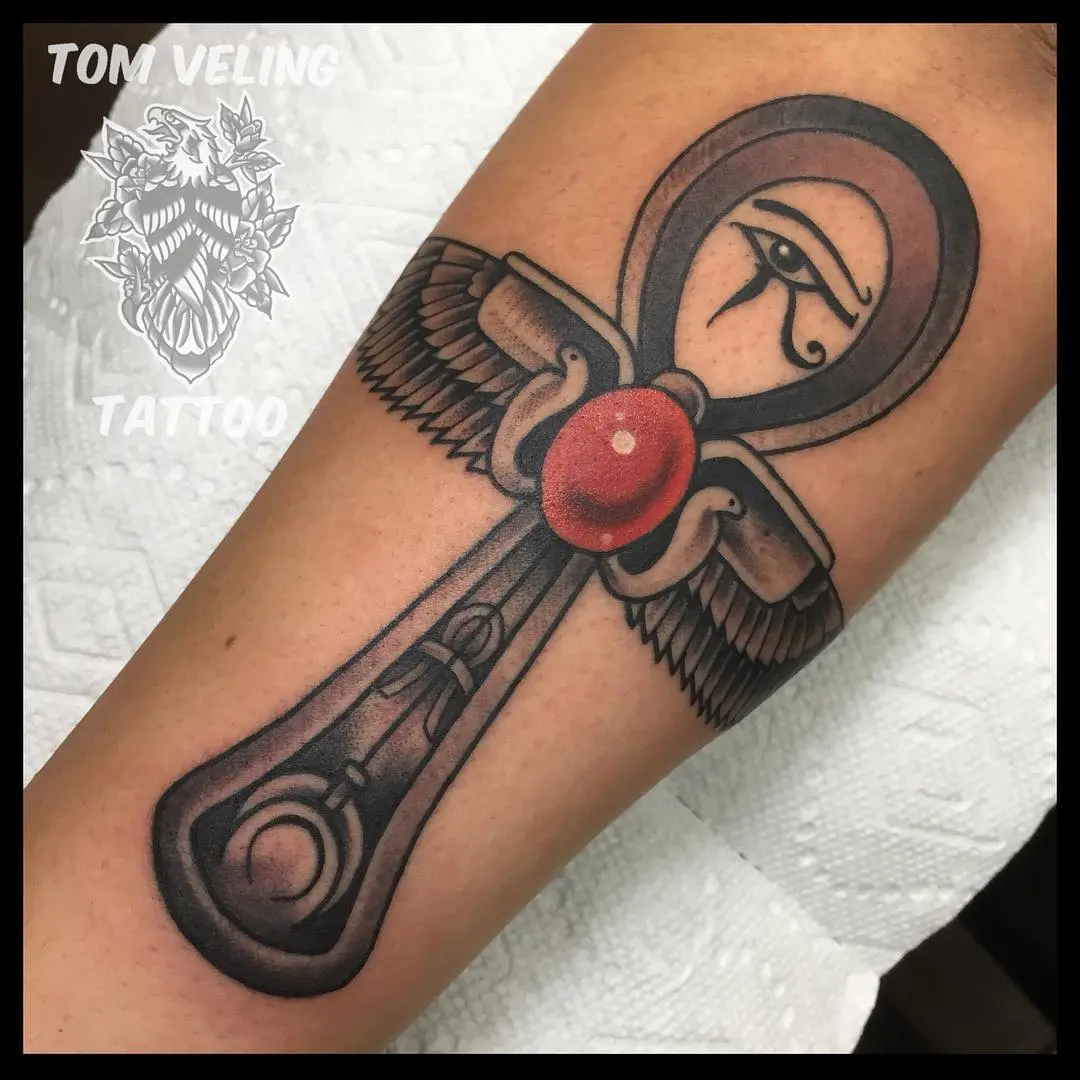 Bold ankh tattoo with eye and wings