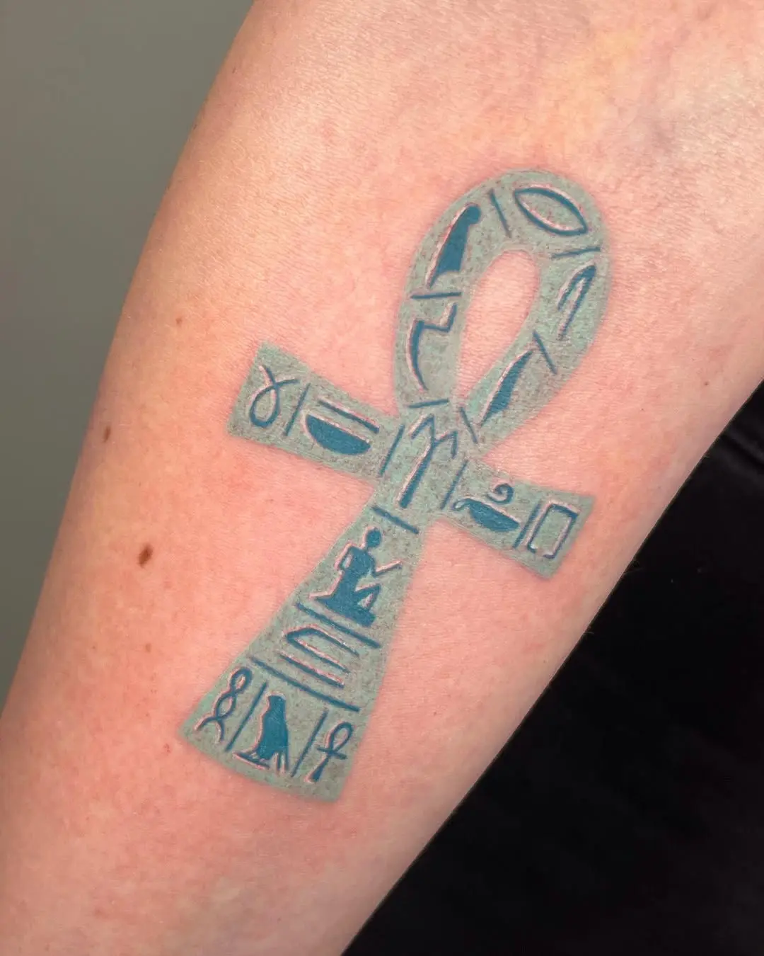 Intricate ankh tattoo with hieroglyphics design