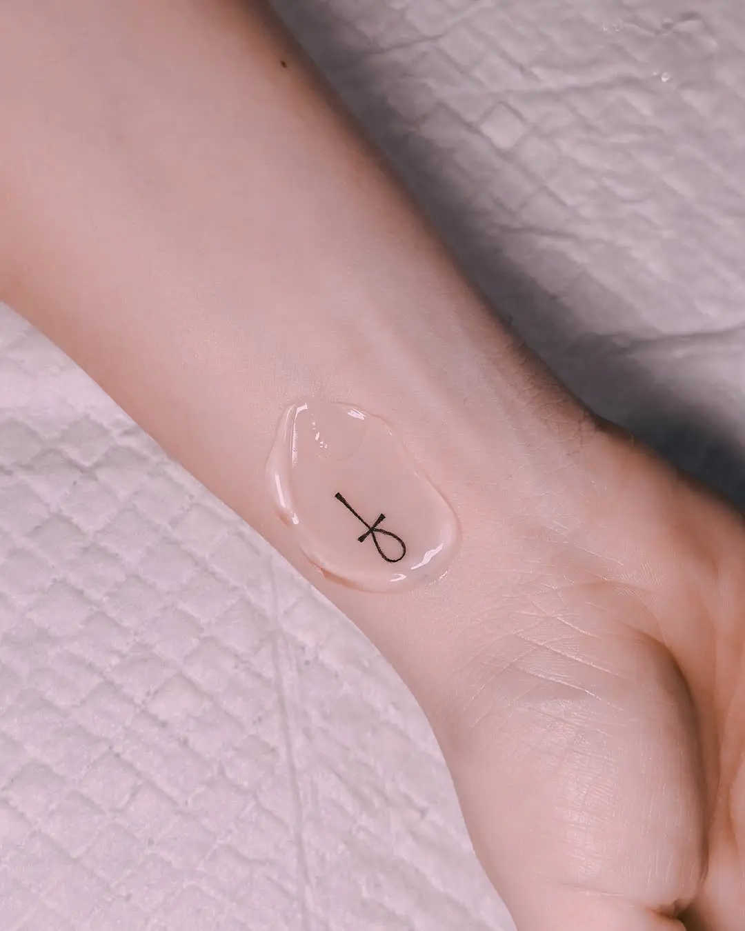 Minimalist ankh tattoo with a modern twist