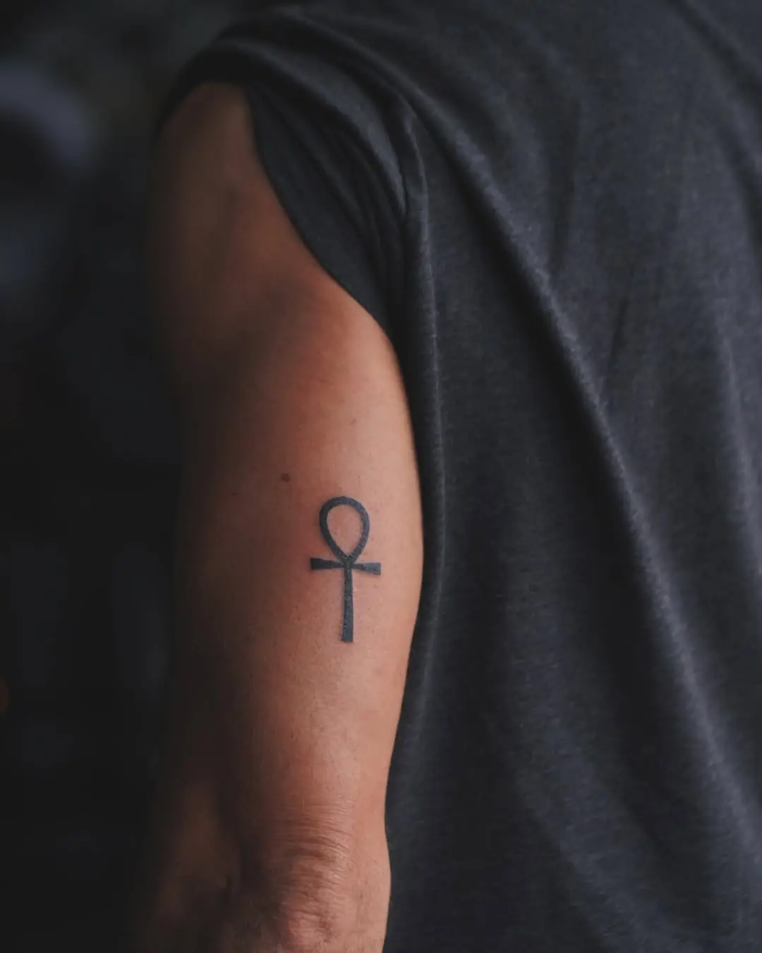 Minimalist Ankh Tattoo on Upper Arm