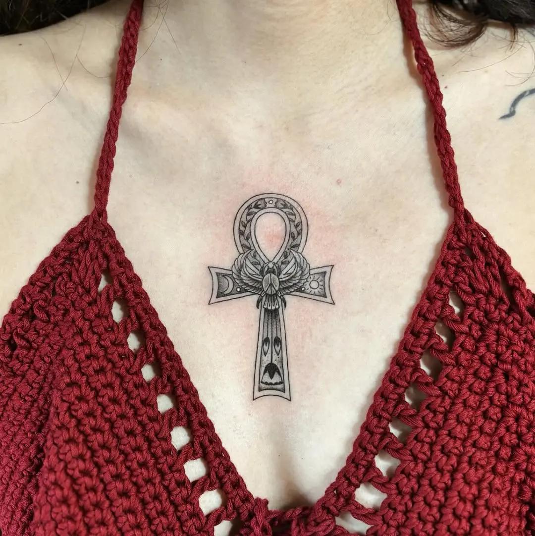 Elegant ankh tattoo with floral accents