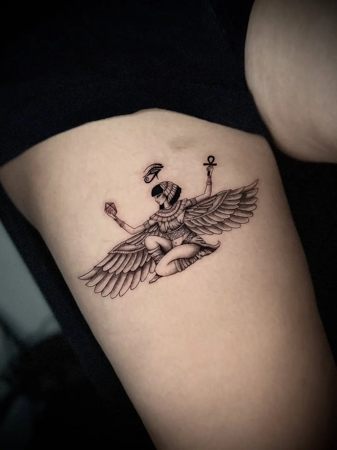 Elegant winged ankh tattoo symbolizes life