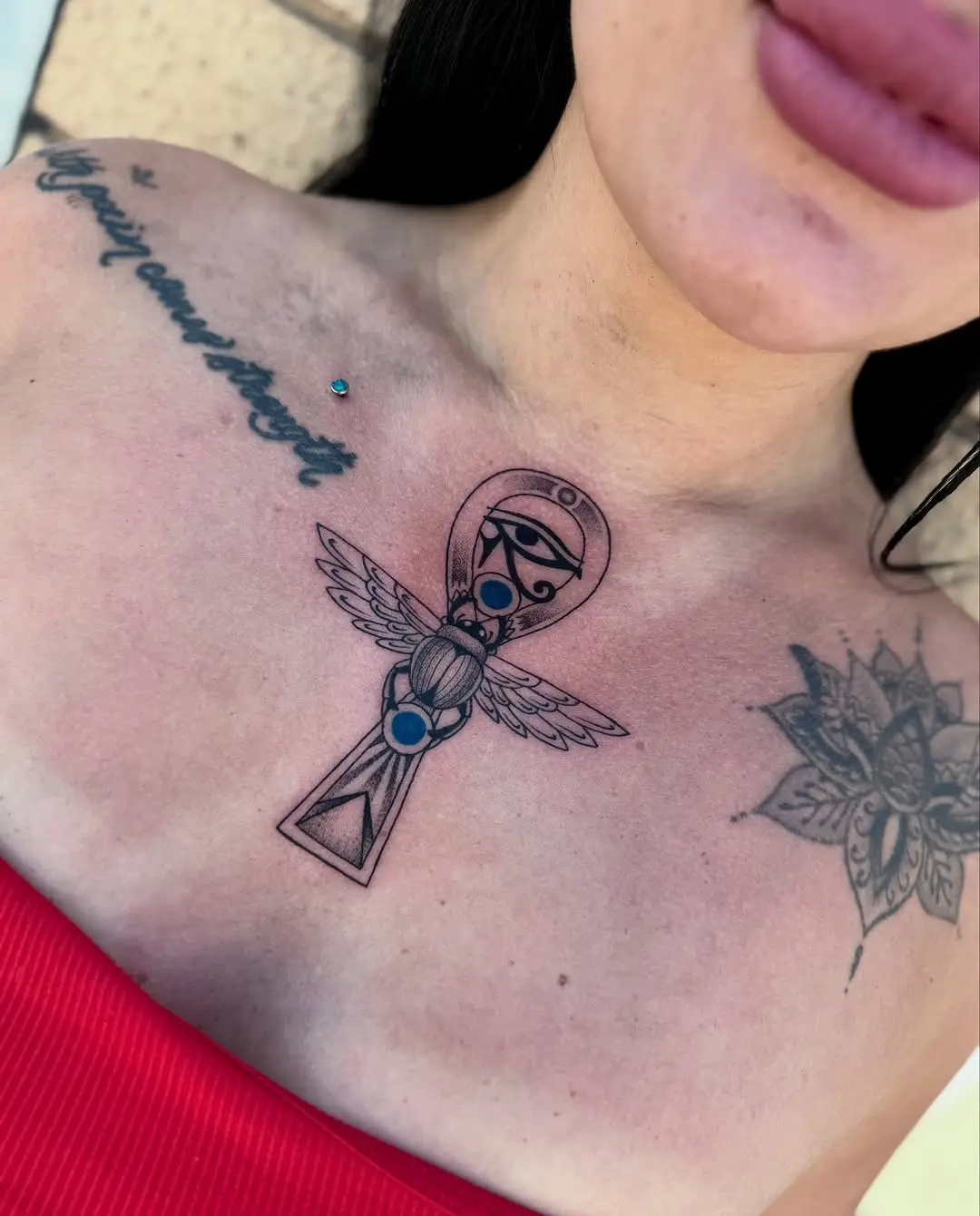 Elegant winged ankh tattoo design on chest