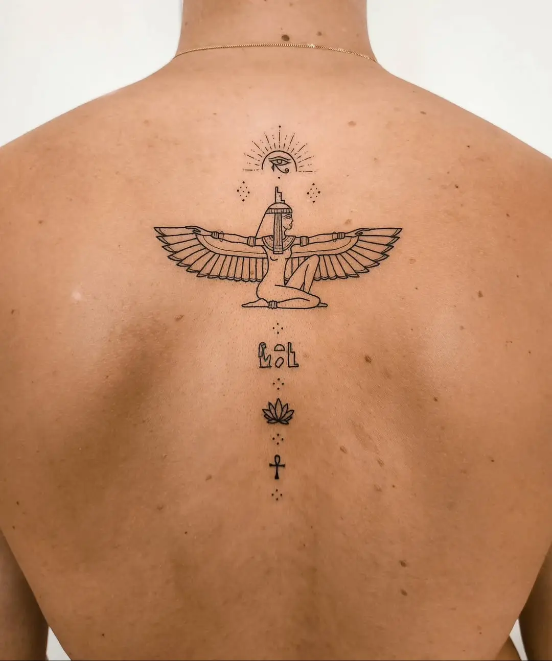 Intricate winged ankh tattoo with symbols