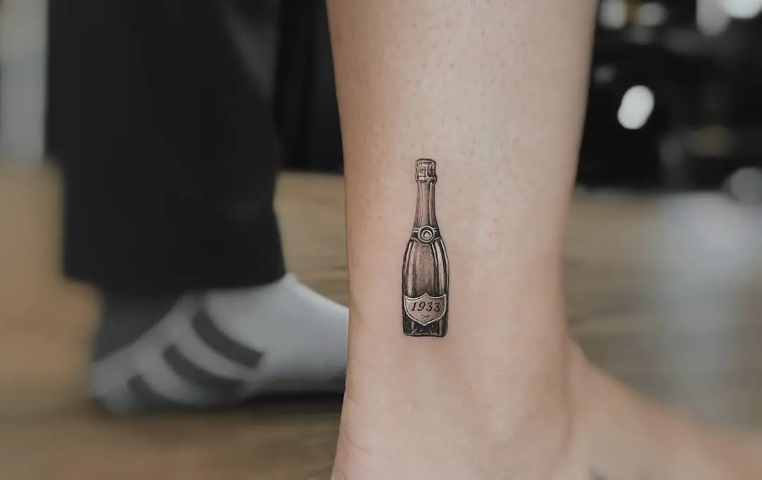 Vintage champagne bottle tattoo with elegant details