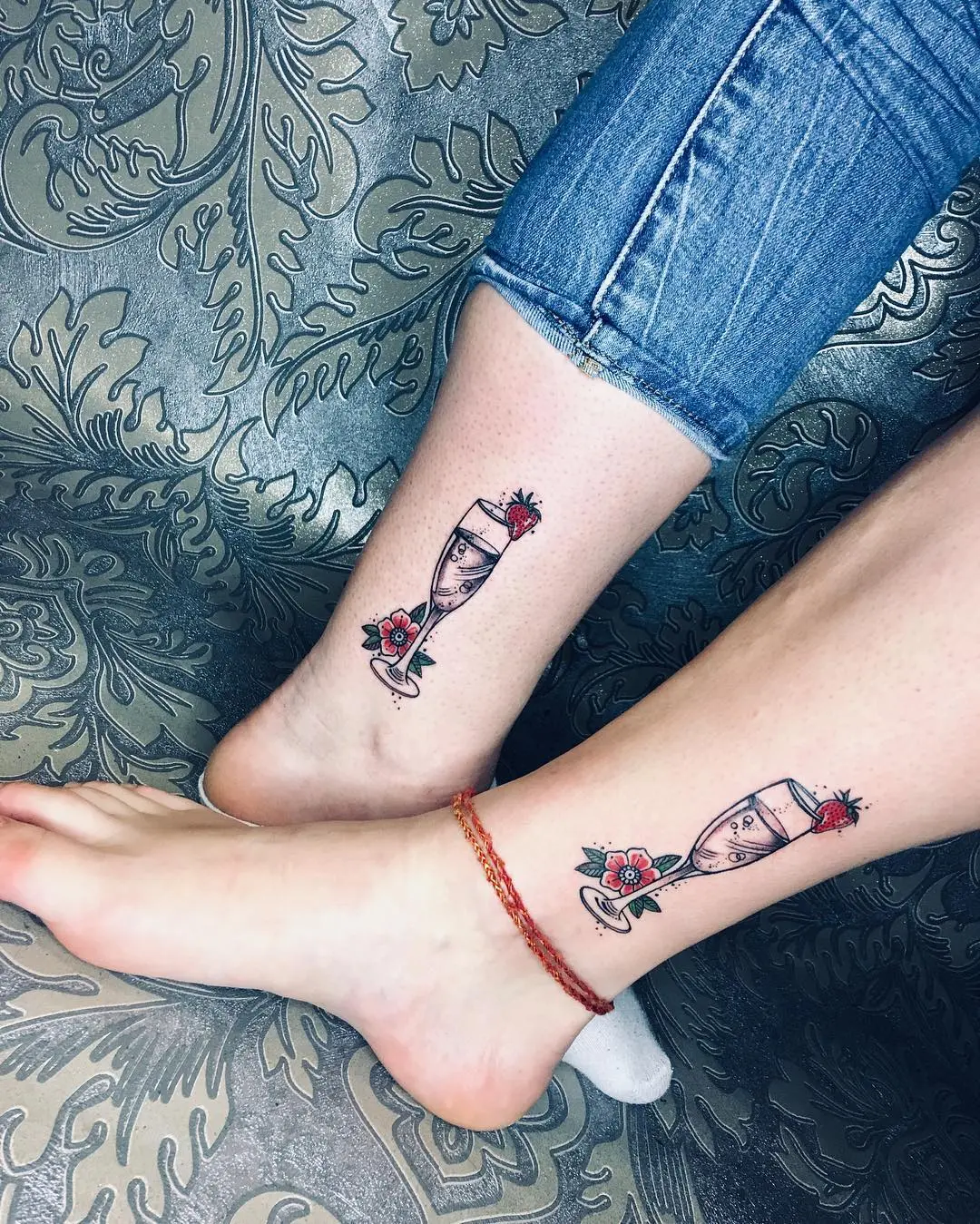 Elegantly designed champagne flute tattoos with flowers