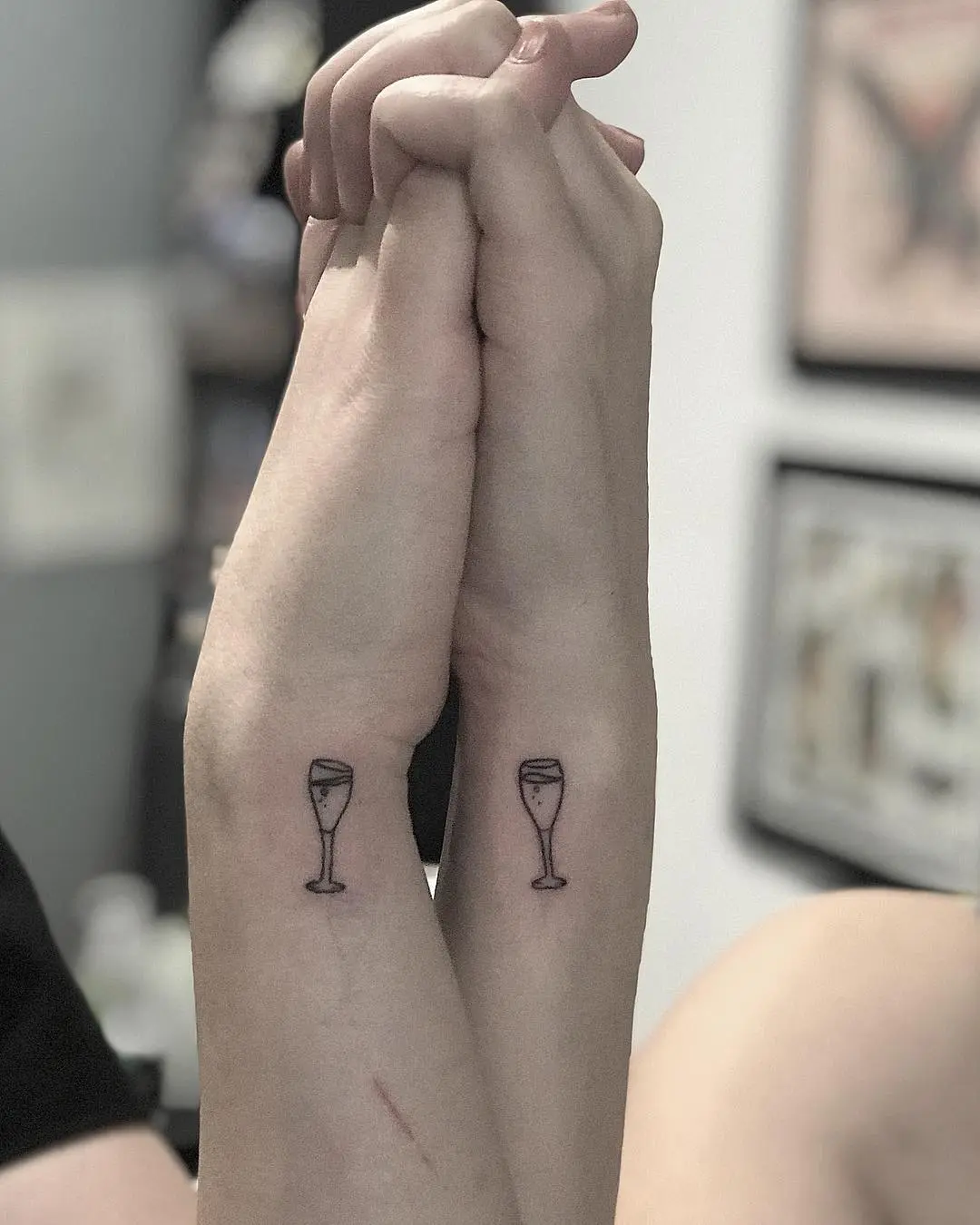 Charming champagne glass tattoos on arms