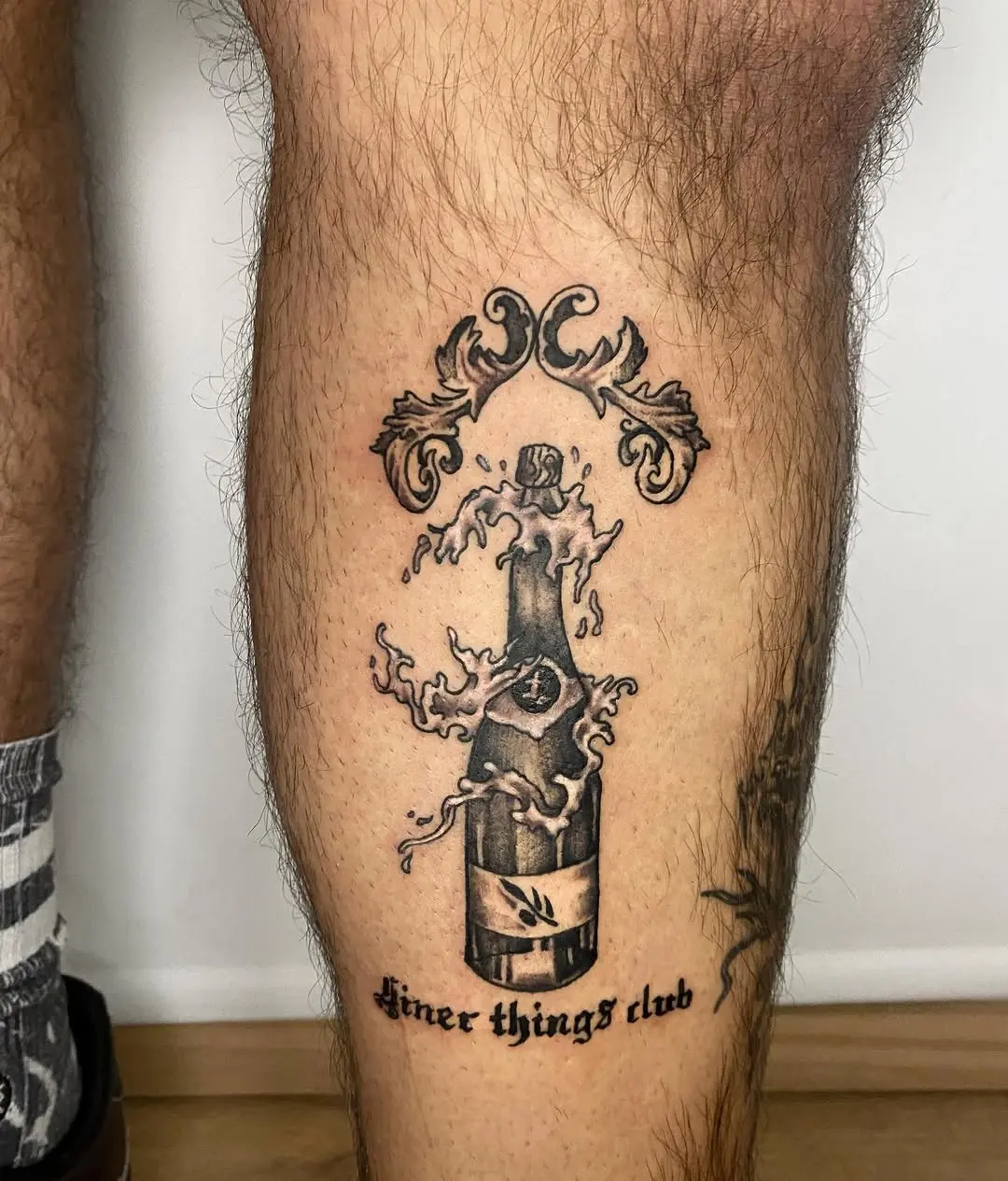 Stylish champagne tattoo with elegant detailing