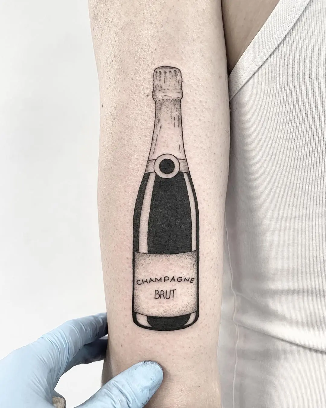 Stylish champagne bottle tattoo in black and white
