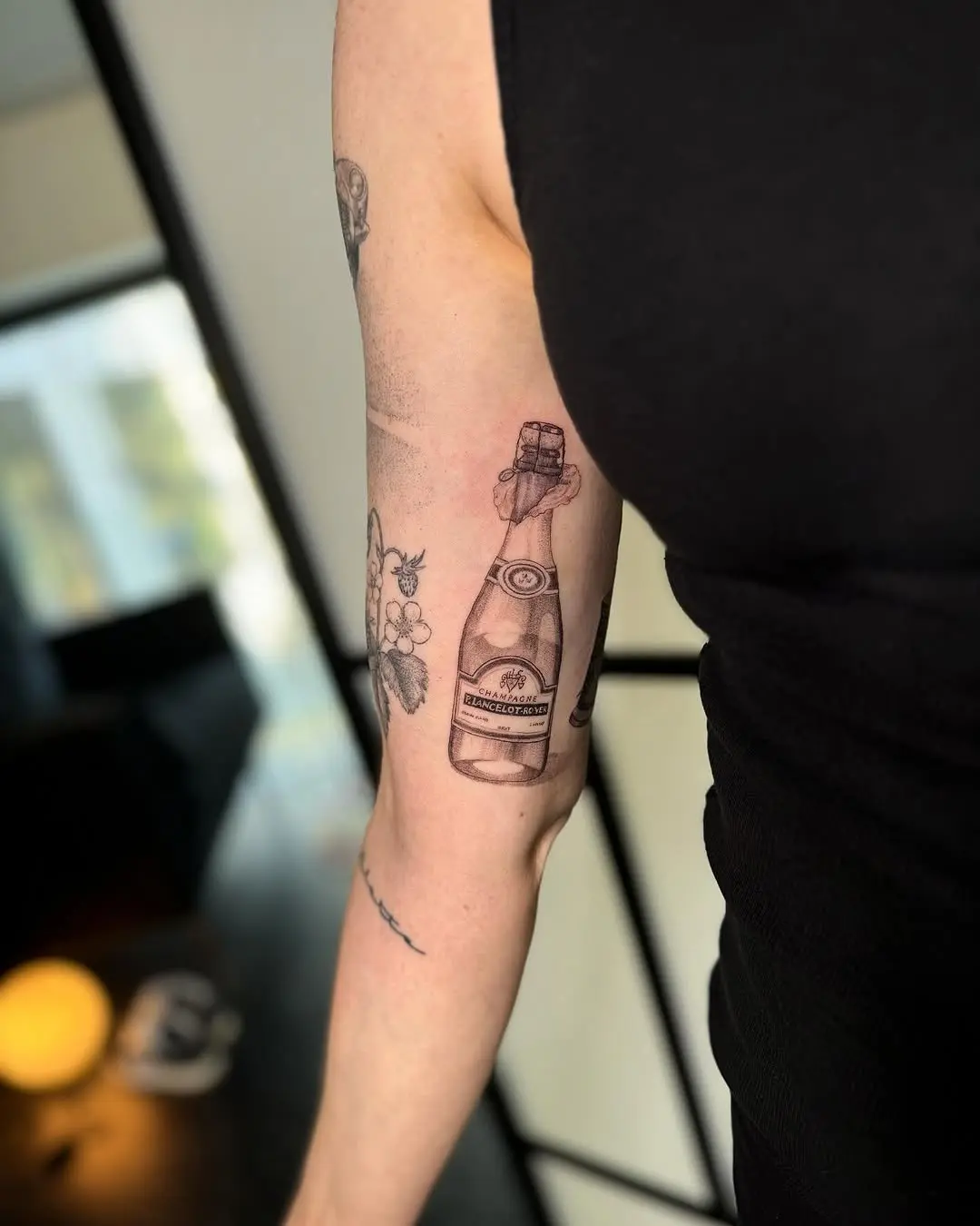 Elegant champagne tattoo with floral accents
