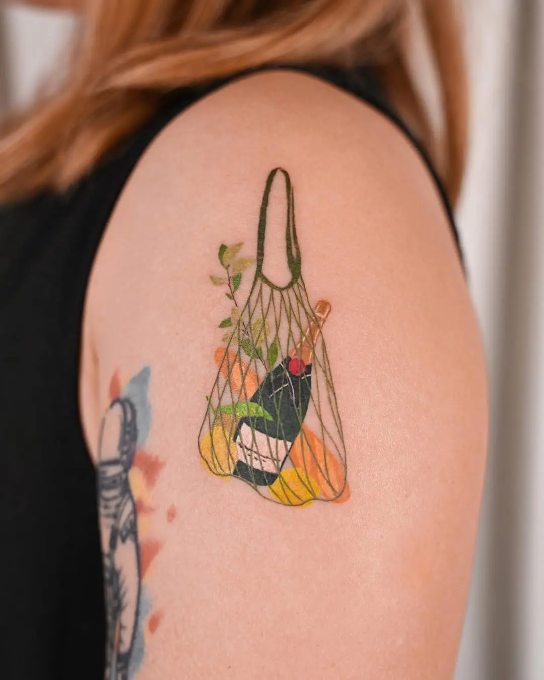 A stylish champagne tattoo in a mesh bag