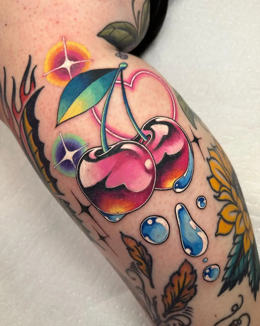 Vibrant neon cherry tattoo with playful vibes