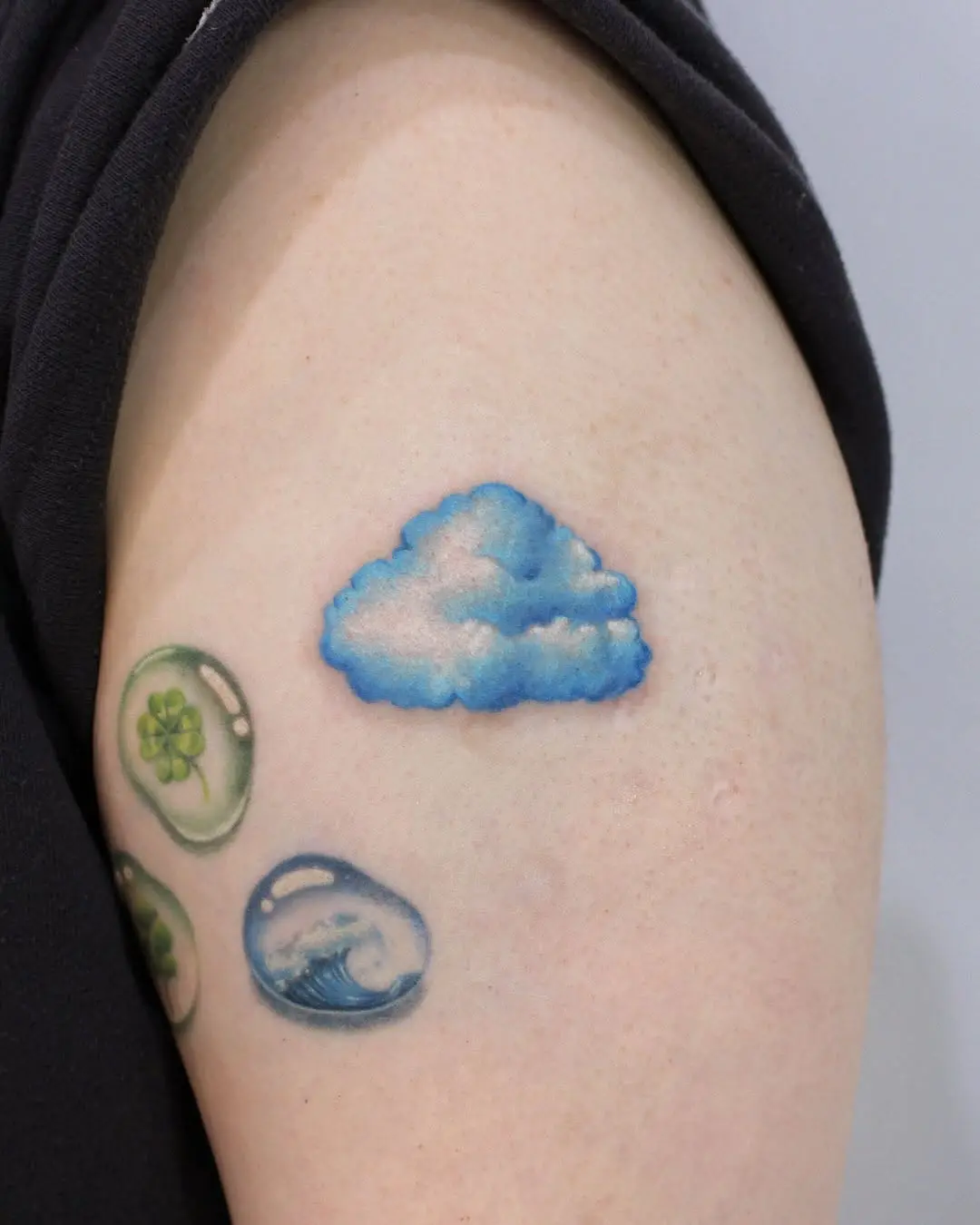 Dreamy Blue Cloud Tattoo on Arm