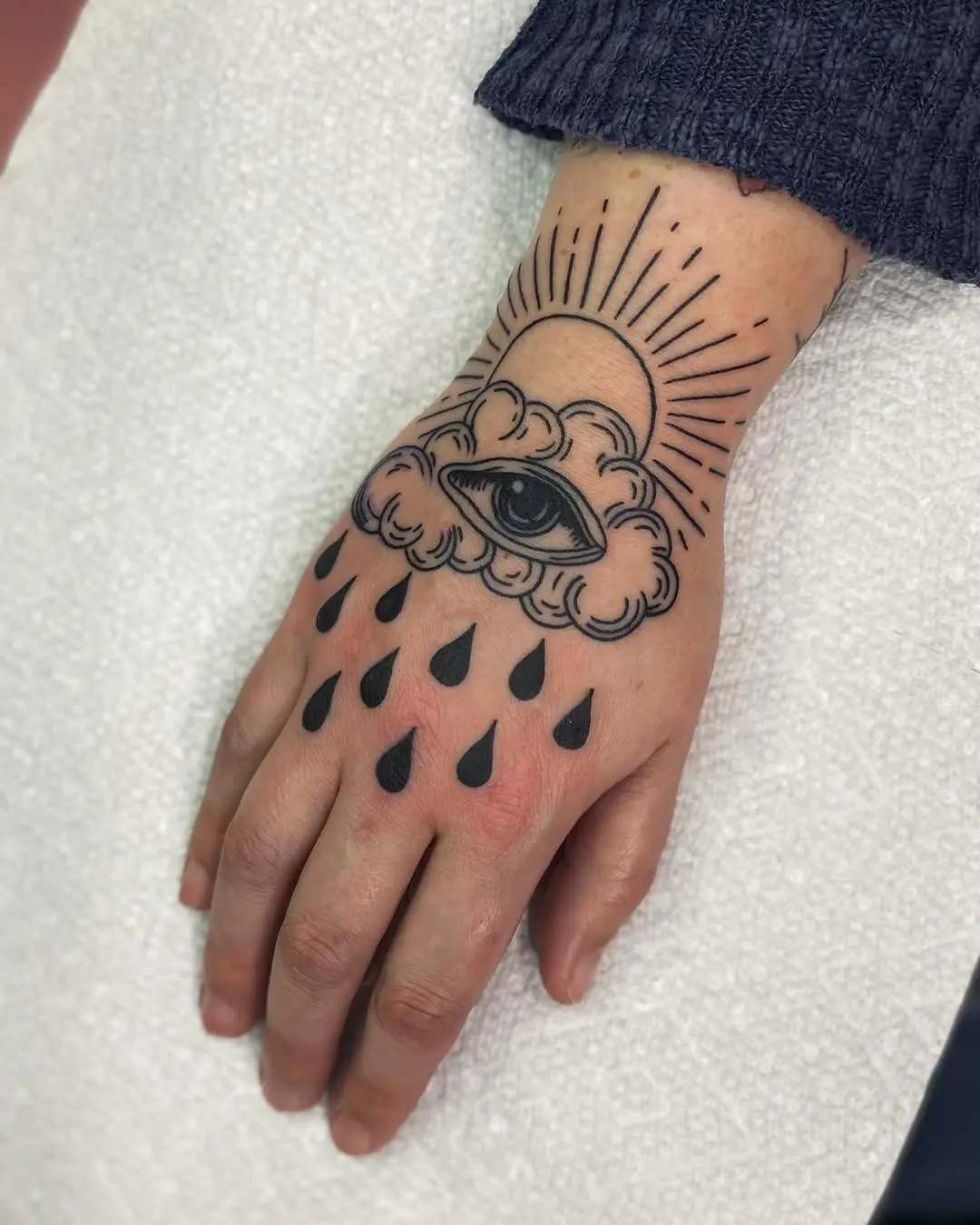 Mysterious cloud tattoo with eye and raindrops