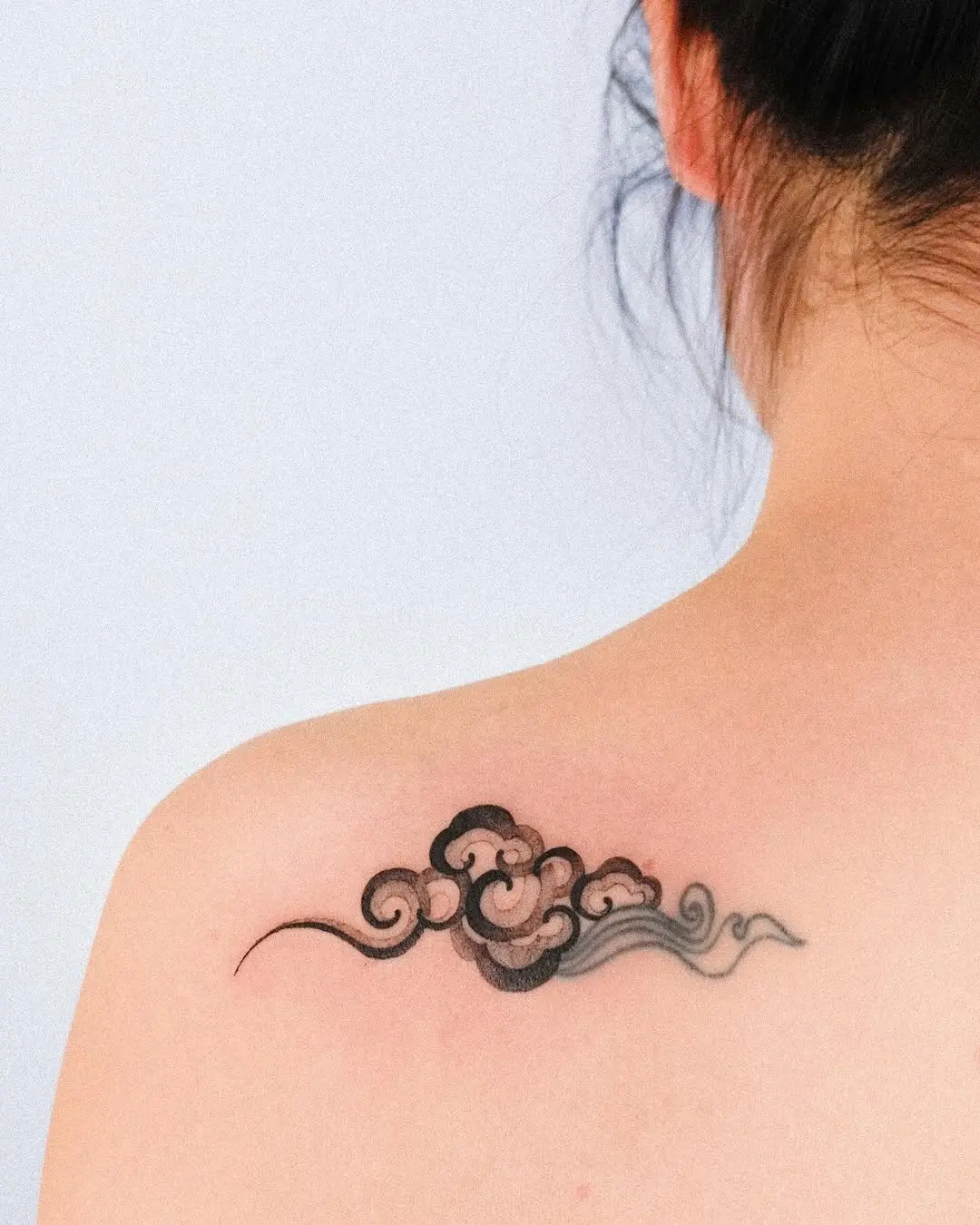 Elegant minimalist cloud tattoo design