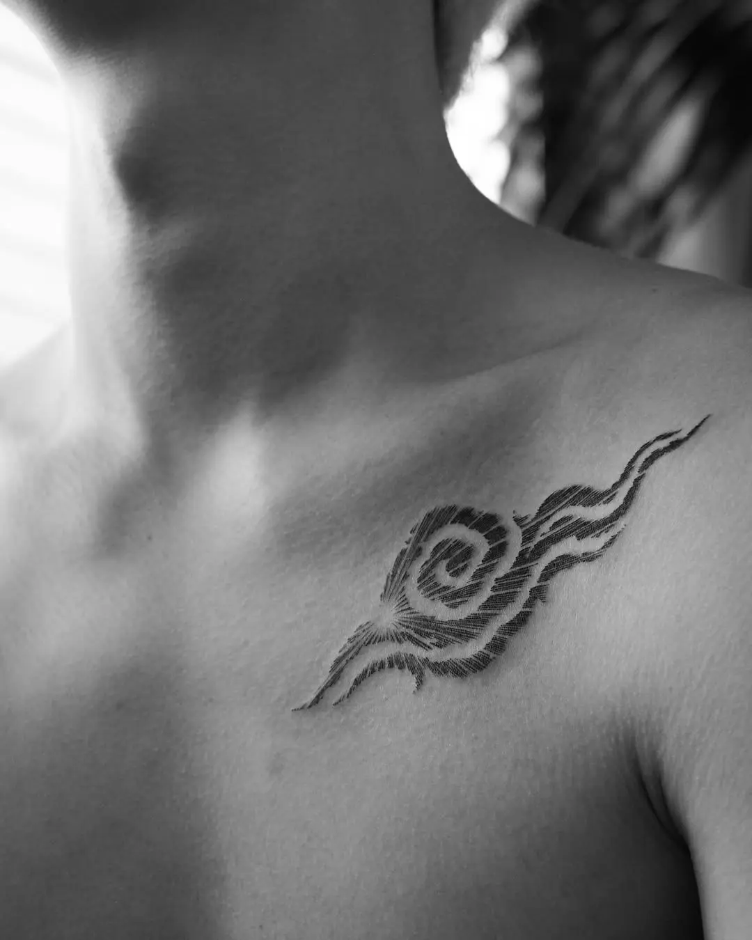 Elegant swirl cloud tattoo on shoulder area