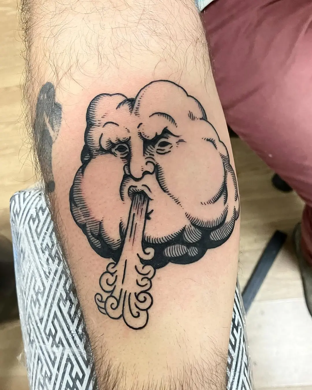 Unique cloud tattoo with a fierce expression