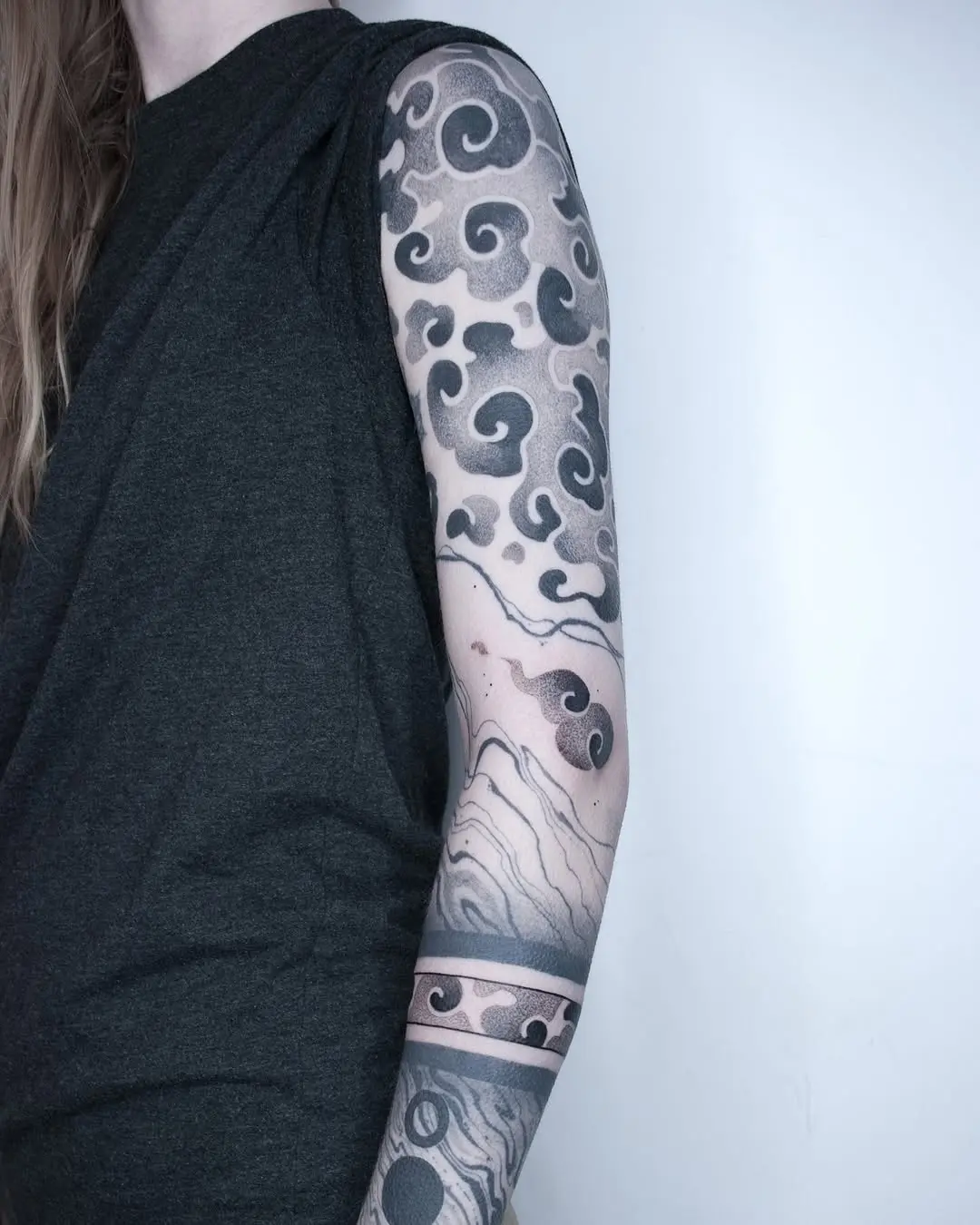 Elegant cloud tattoos with intricate details