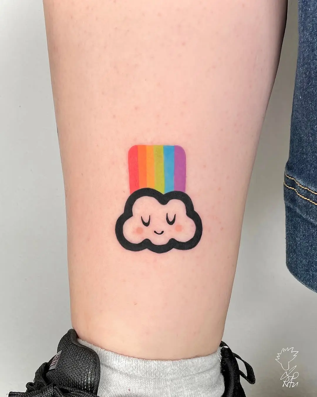 Playful cloud tattoo with rainbow elements
