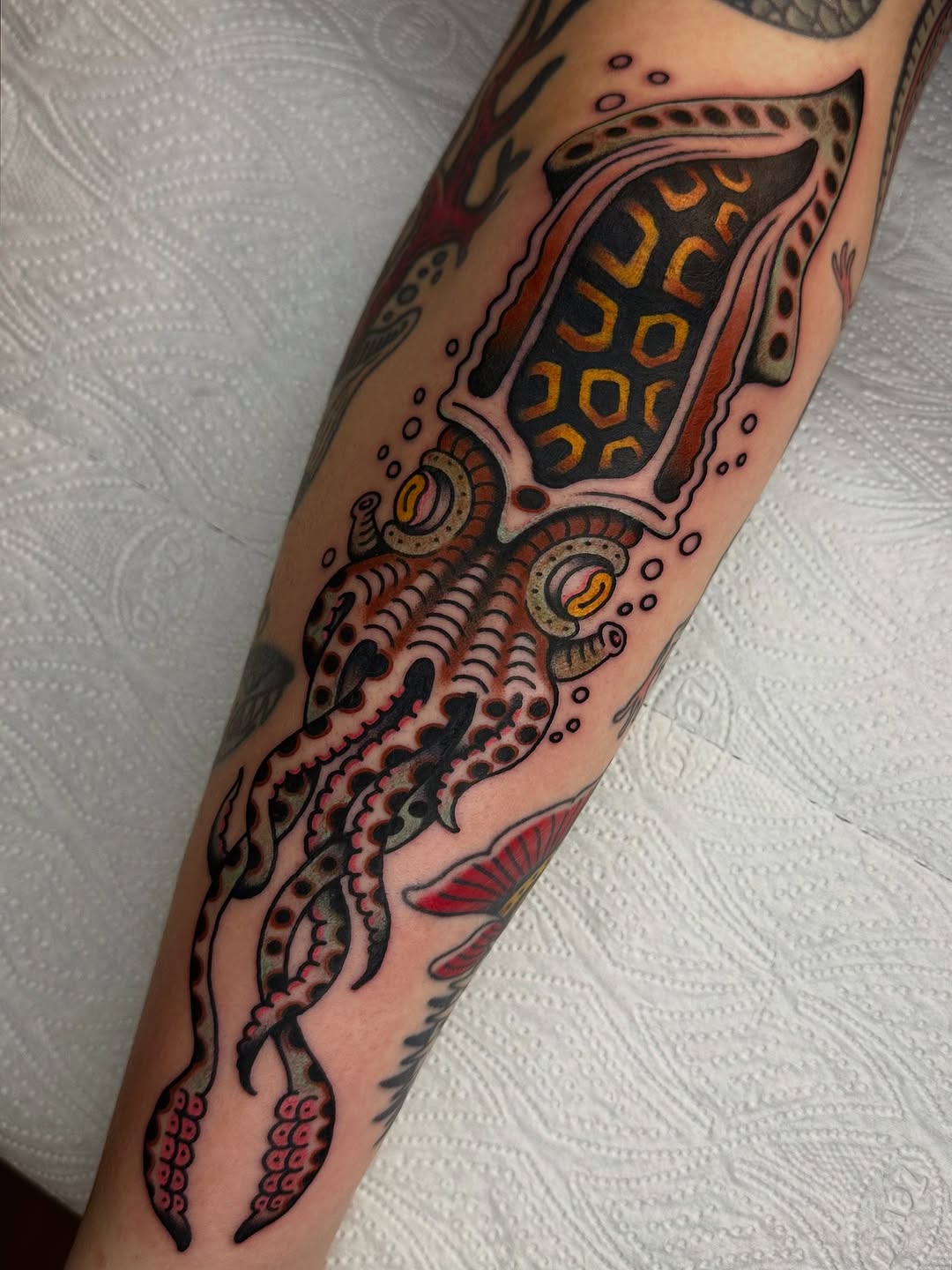 Vibrant squid tattoo showcasing geometric patterns