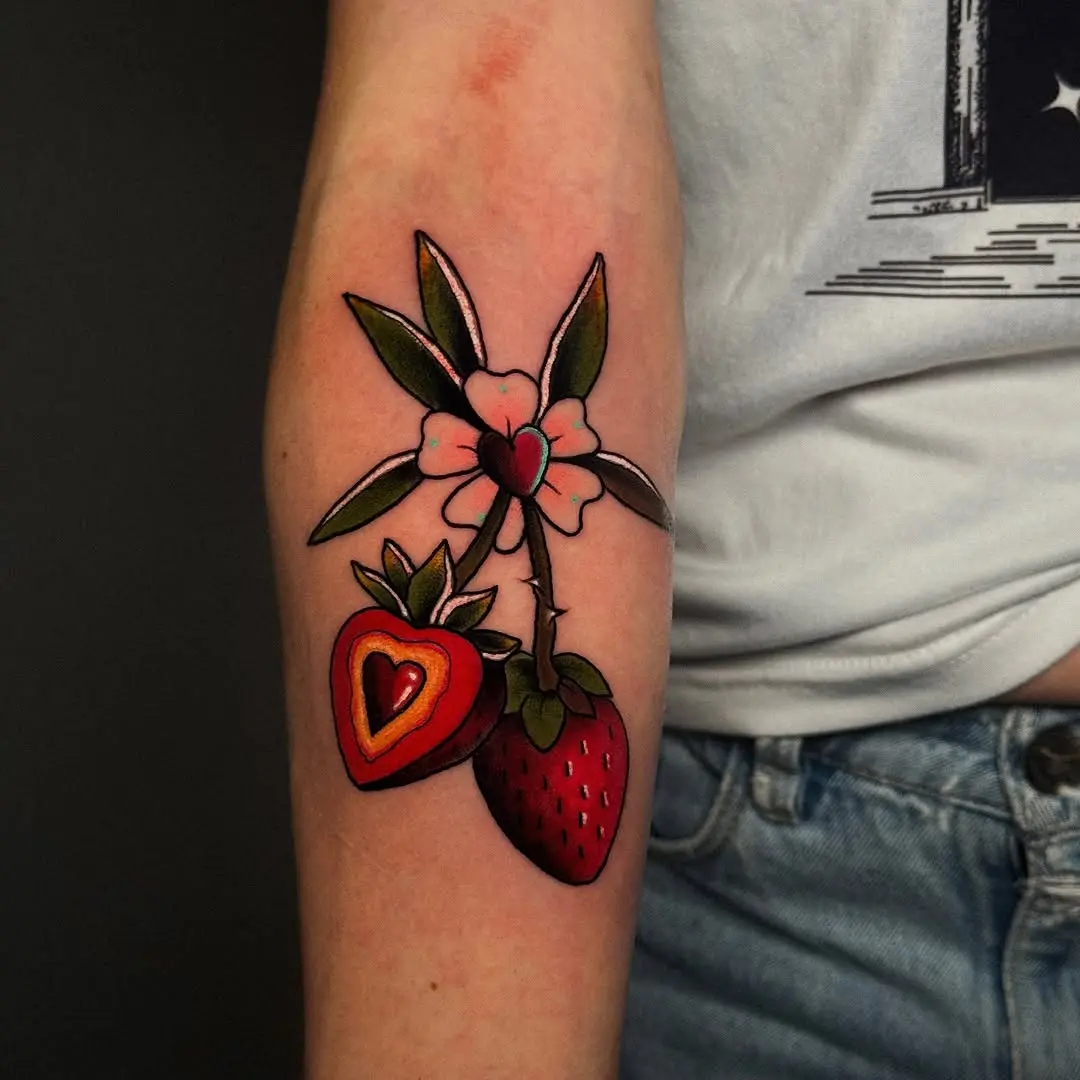 Vibrant strawberry tattoo with floral elements
