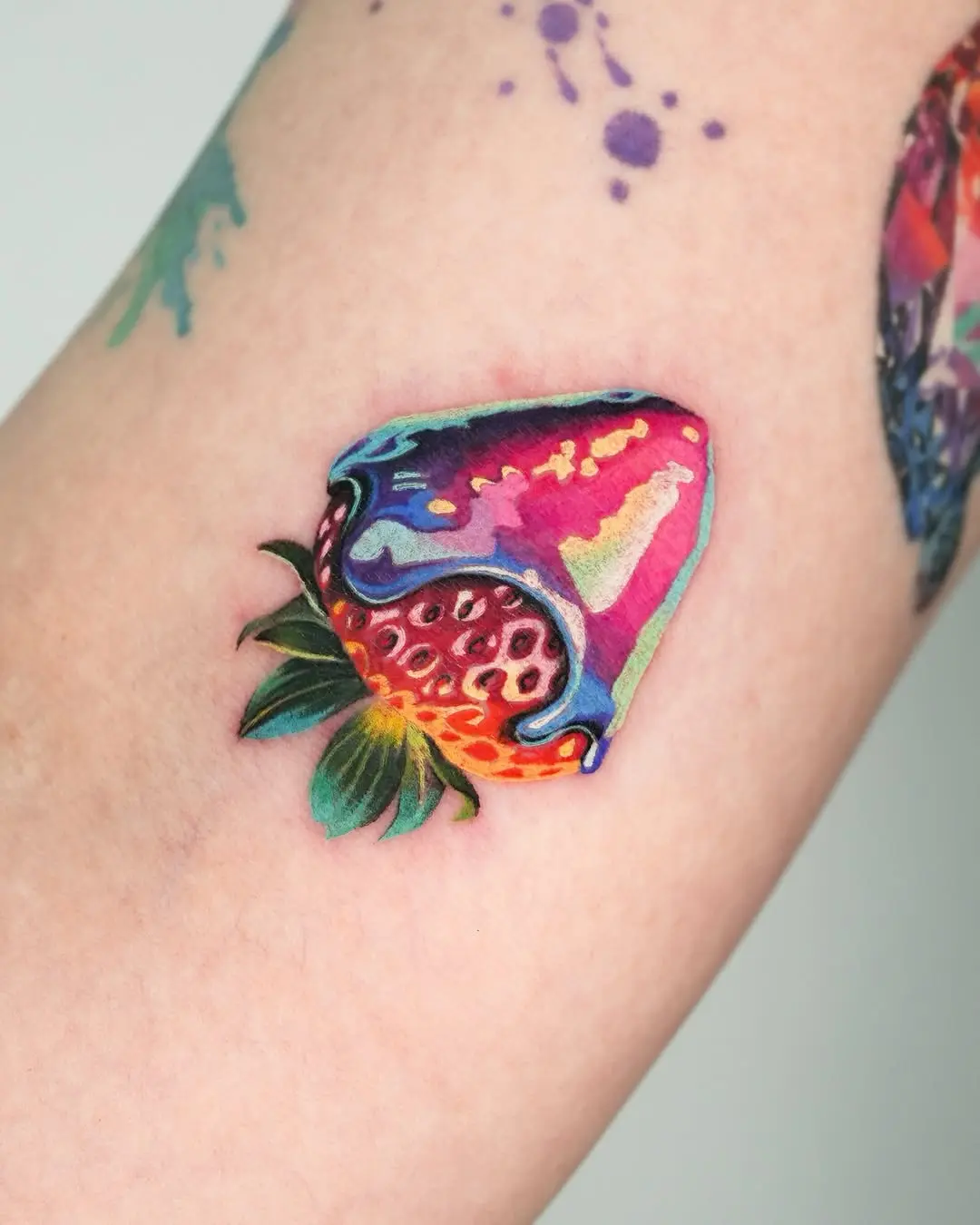Vibrant strawberry tattoo dripping with color