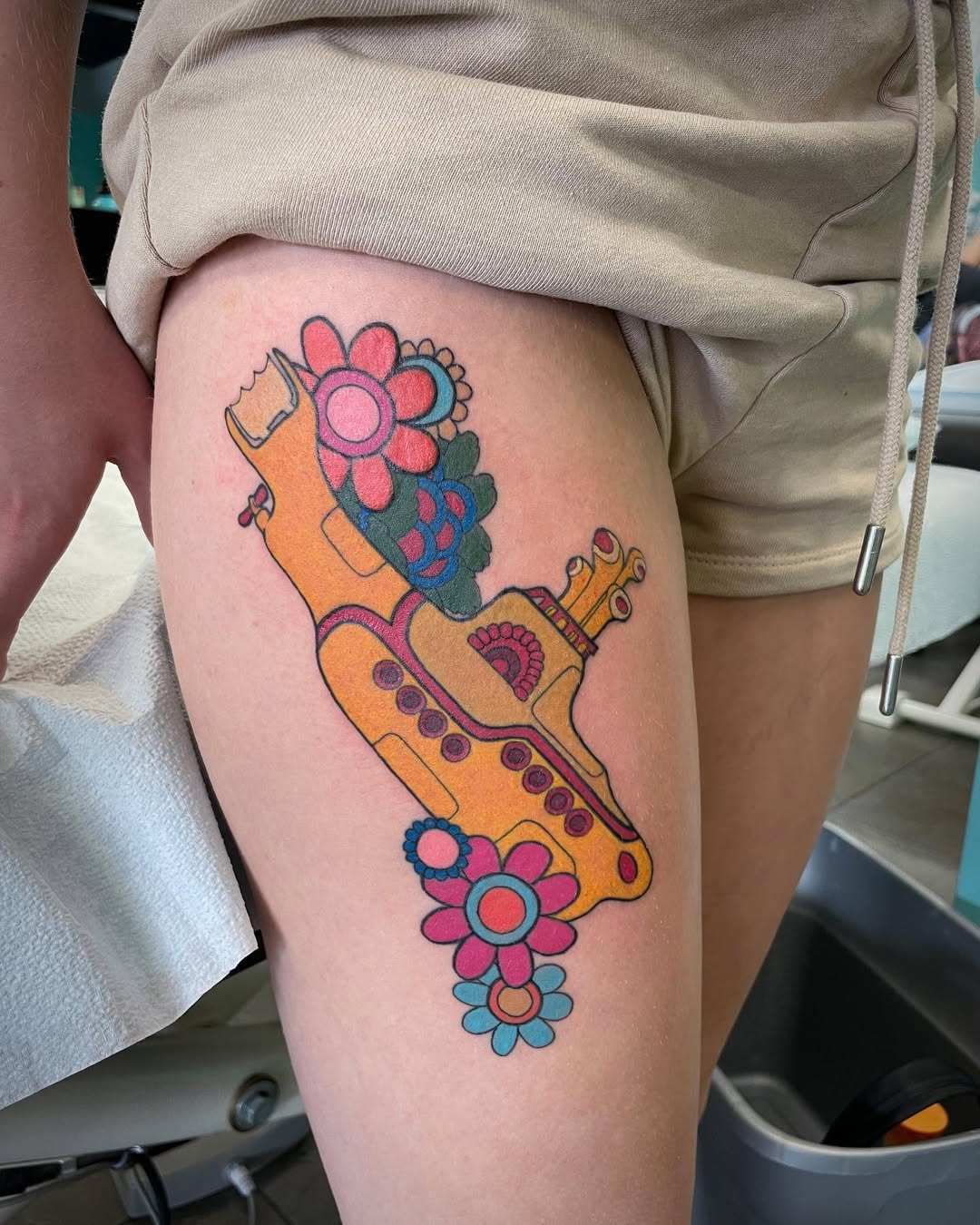 Whimsical submarine tattoo adorned with flowers