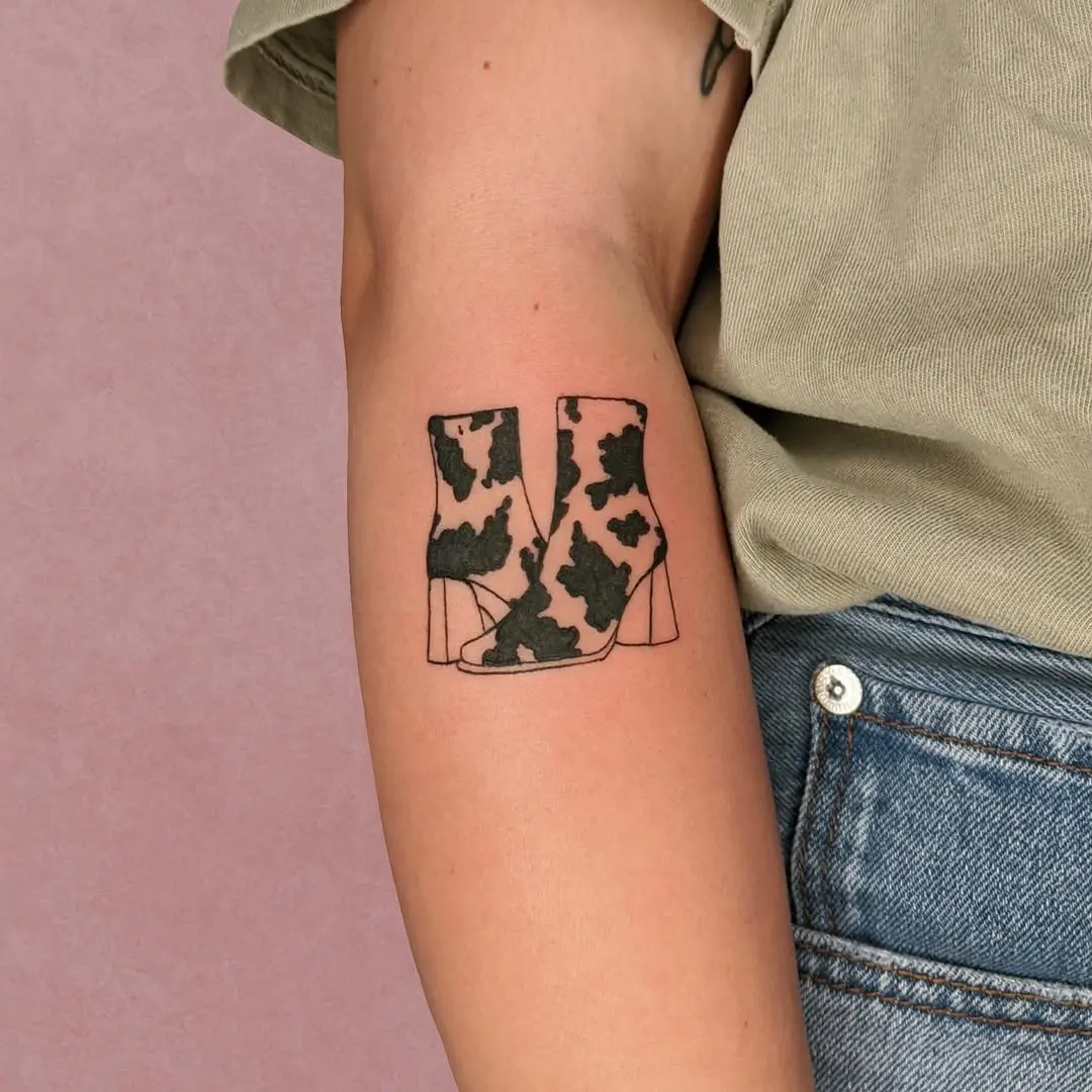 Chic cow-print boot tattoo for fashion lovers