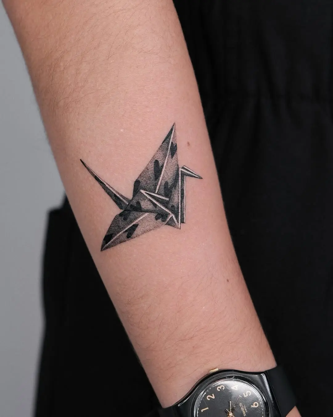 Elegant origami crane tattoo with intricate details